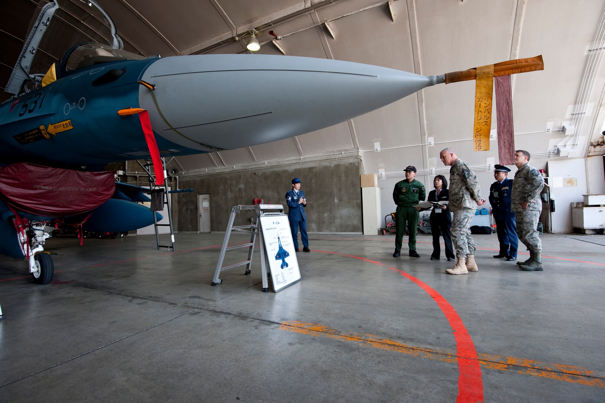 MISAWA AIR BASE, Japan -- Chief Master Sgt. Brook McLean, Pacific Air Forces command chief master sergeant, learns about the Japan Air Self-Defense Force F-2 fighter jet April 9. After touring the 35th Fighter Wing, Chief McLean took a day to learn more about the cultural and technological differences of their JASDF counterparts. (U.S. Air Force photo/Staff Sgt. Samuel Morse)