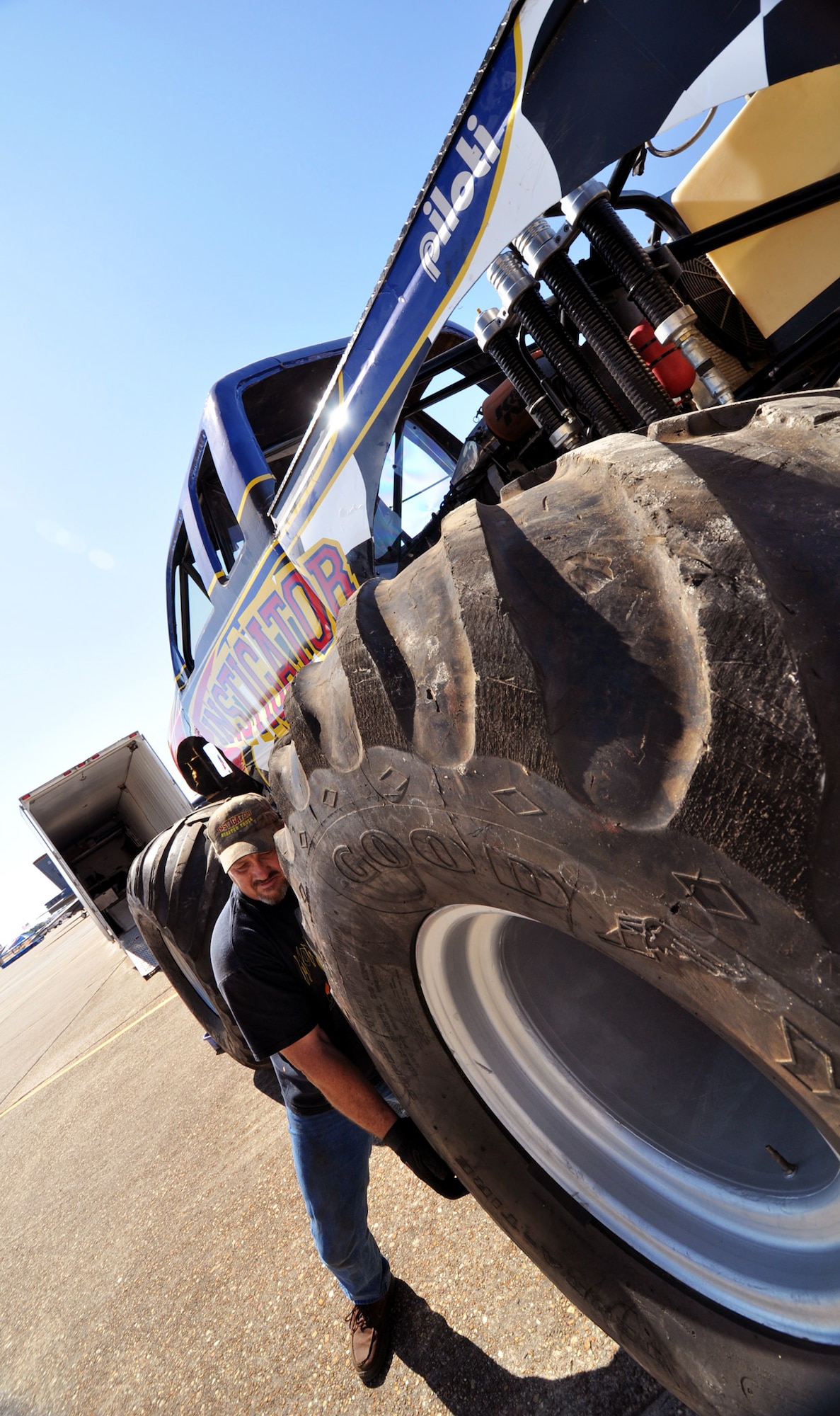 Lionel Easler rolls the "monster" tires into place on his truck "The Instigator," April 9 in preparation for the weekend airshow at Eglin Air Force Base, Fla.  The truck was on display with the Air Force Reserve recruiting booth.  Mr. Easler has been driving monster trucks for five years and competes in about 35 truck shows a year.  This was the first airshow however for the Florida native.  (U.S. Air Force photo/Tech. Sgt. Samuel King Jr.)  (U.S. Air Force photo/Tech. Sgt. Samuel King Jr.)