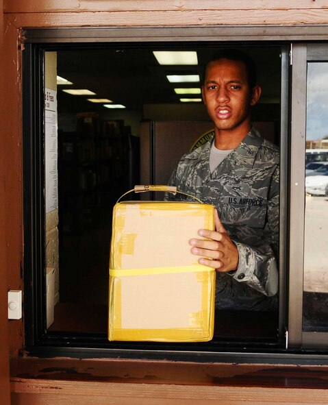 ANDERSEN AIR FORCE BASE, Guam ? Senior Airman Brandon Gordon helps a postal service customer here on April 9, 2010. Airman Gordon plays a key role in delivering more than 1 million pounds of mail per year to members of the Andersen team. (U.S. Air force photo by Airman 1st Class Jeffrey Schultze)