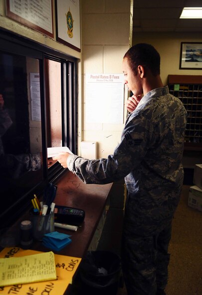 ANDERSEN AIR FORCE BASE, Guam ? Senior Airman Brandon Gordon helps a postal service customer here on April 9, 2010. Airman Gordon plays a key role in delivering more than 1 million pounds of mail per year to members of the Andersen team. (U.S. Air force photo by Airman 1st Class Jeffrey Schultze)