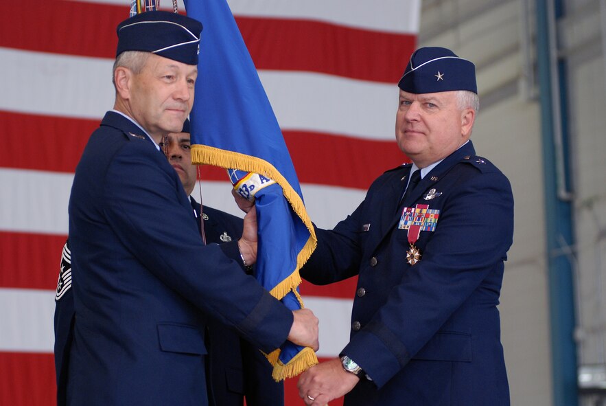 Members of the 433rd Airlift Wing formally recognize Col. Kenneth Lewis as the new wing commander during a change of command ceremony held in the fuel cell hangar at Lackland Air Force Base, Texas. Brig. Gen. John Fobian is the outgoing wing commander. (U.S. Air Force photo/Airman 1st Class Brian McGloin)