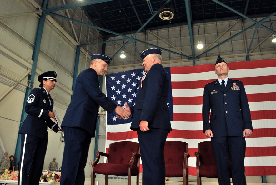 Members of the 433rd Airlift Wing formally recognize Col. Kenneth Lewis as the new wing commander during a change of command ceremony held in the fuel cell hangar at Lackland Air Force Base, Texas. Brig. Gen. John Fobian is the outgoing wing commander. (U.S. Air Force photo/Airman 1st Class Brian McGloin)