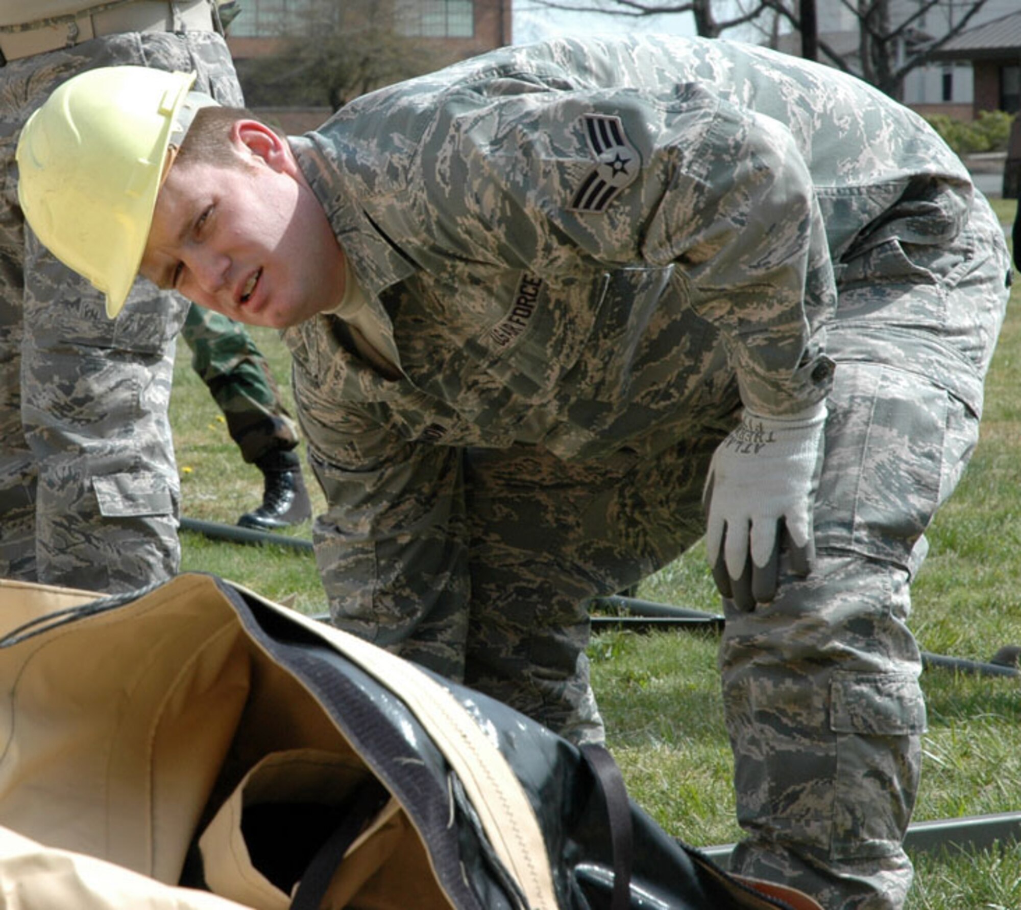 JOINT BASE LEWIS-MCCHORD, Wash. -- Senior Airman Ben Lubenow, a Reservist with the 446th Services Flight here, helps lift into place a single pallet expeditionary kitchen, or S.P.E.K., during a training exercise April 10.  A S.P.E.K. has the capability to serve hundreds of meals to hungry troops in austere deployed environments. (U.S. Air Force photo/Staff Sgt. Grant Saylor)