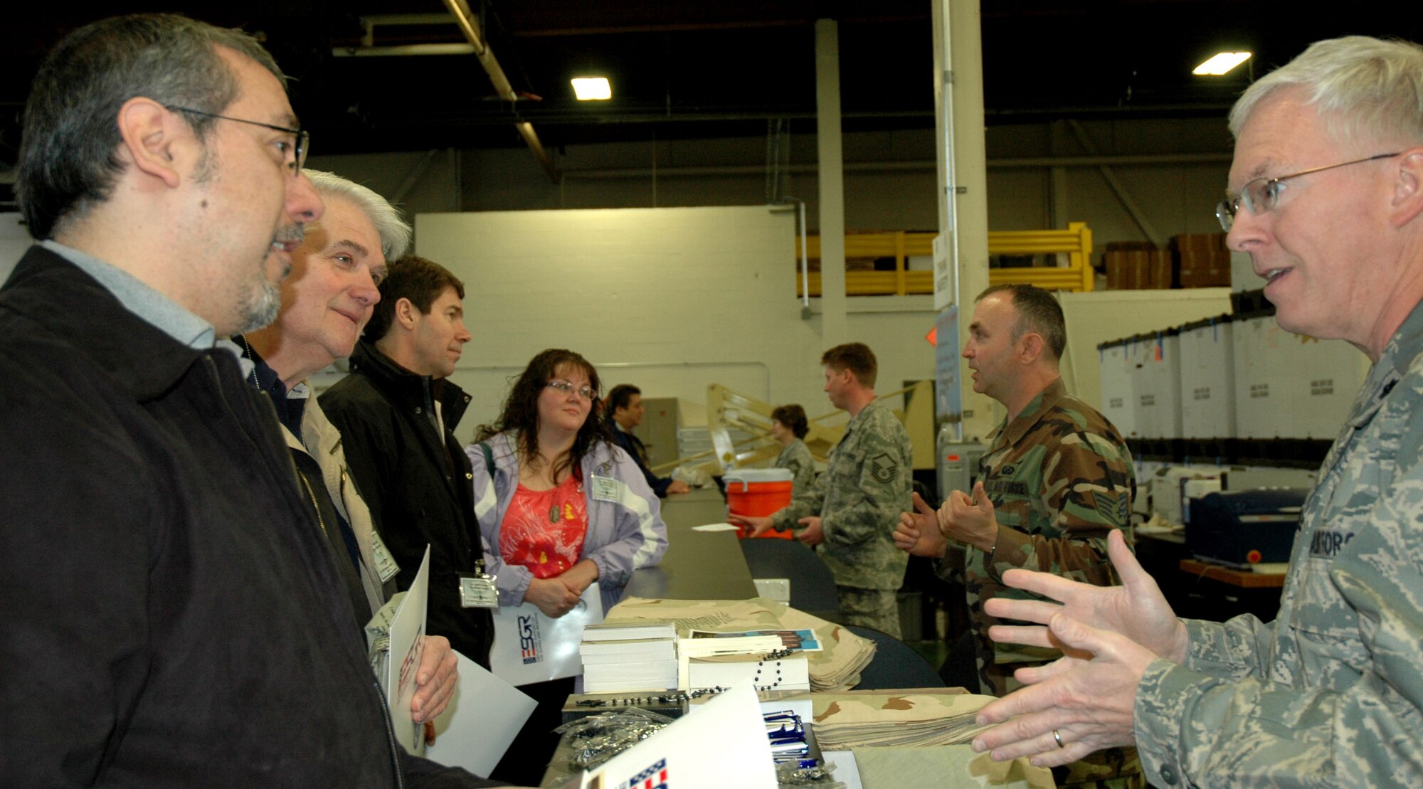 JOINT BASE LEWIS-MCCHORD, Wash. - Chaplain (Lt. Col. ) Carl Supplee, (right, foreground) 446th Airlift Wing Chapel,  Mission Support Squadron Airman and Family Readiness Center director, here, talks to employeers about his role as a chaplain.  Switching hats, he also spoke to the employers about the mission and services of the 446th Mission Support Squadron's Airmen and Family Readiness Center, which he is director of in his civilian employment capacity. Civiian employers of Reservists took part April 10 in the bi-annual 446th Airlift Wing Employer Orientation Day. (U.S. Air Force photo/Staff Sgt. Nicole Celestine)