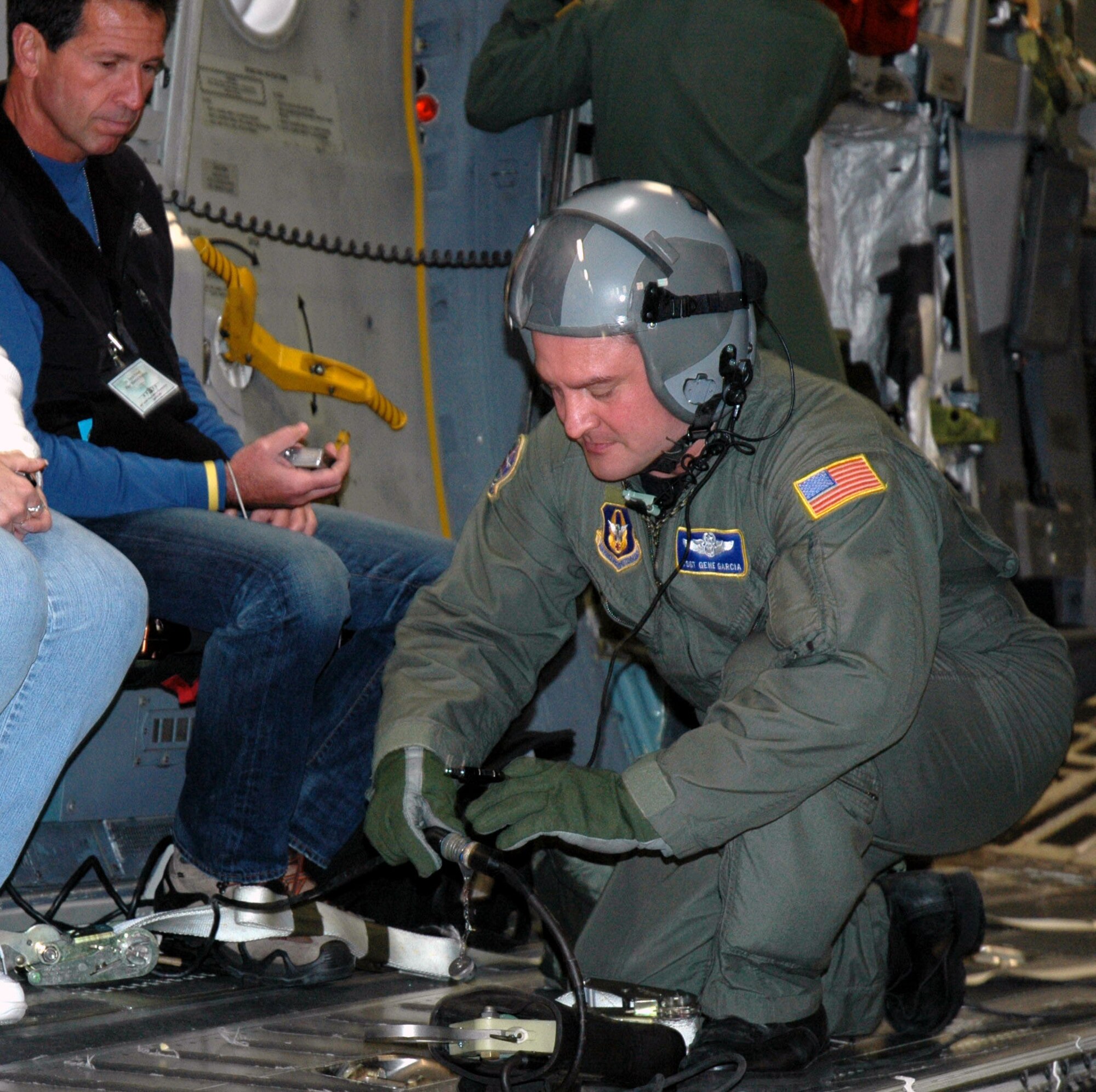 JOINT BASE LEWIS-MCCHORD, Wash. - Tech. Sgt. Gene Garcia, loadmaster with the 728th Airlift Squadron here, secures some wires aboard the C-17 Globemaster III aircraft, during the 446th Airlift Wing's Employer Orientation Day, here April 10. This event gives employers a first-hand look at what their Reservists do on drill weekends, annual tours and deployments. The next 446th AW Employer Orientation Day will be on the October primary UTA. (U.S. Air Force photo/Staff Sgt. Nicole Celestine)