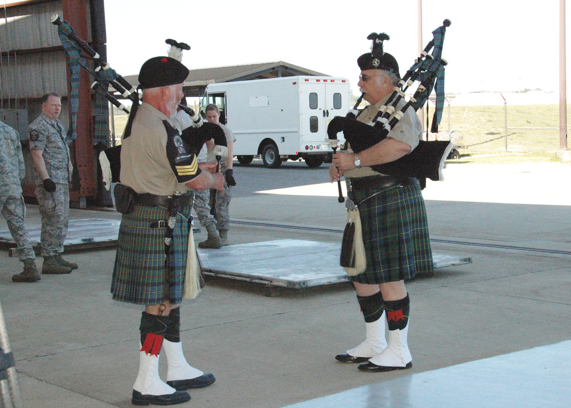 Pipe Sgt. Bob Andruss (left) and Pipe Maj. Bob Horner of the Destin-based 23rd Highlanders pipe and drum band play "Scotland the Brave" on the tarmac at Hurlburt Field April 6.  The musicians volunteered to perform during Operation Homecoming, an event that reunited returning Duke Field and Hurlburt warfighters with family, fellow Airmen and local civic leaders following lengthy deployments in support of operations in Southwest Asia. (U.S. Air Force photo/Dan Neely)