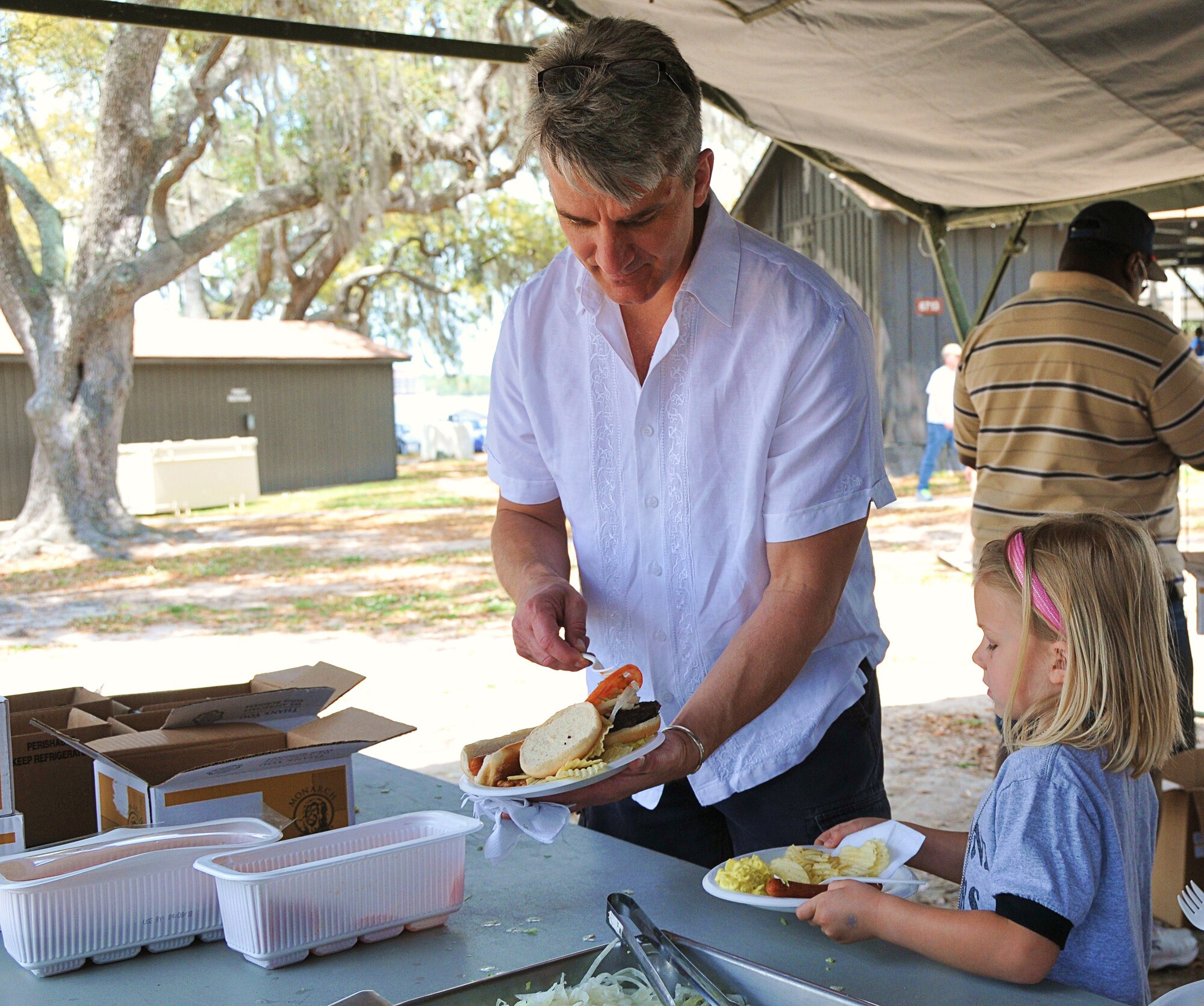 Lt. Col. Jason May, 53rd Weather Reconnaissance Squadron commander, Keesler Air Force Base, Miss., and daughter Amelia fill up their plates April 10 at the base marina. More than 1500 Reservists and their families attended the second annual Wing Family Day, hosted by the 403rd Wing.