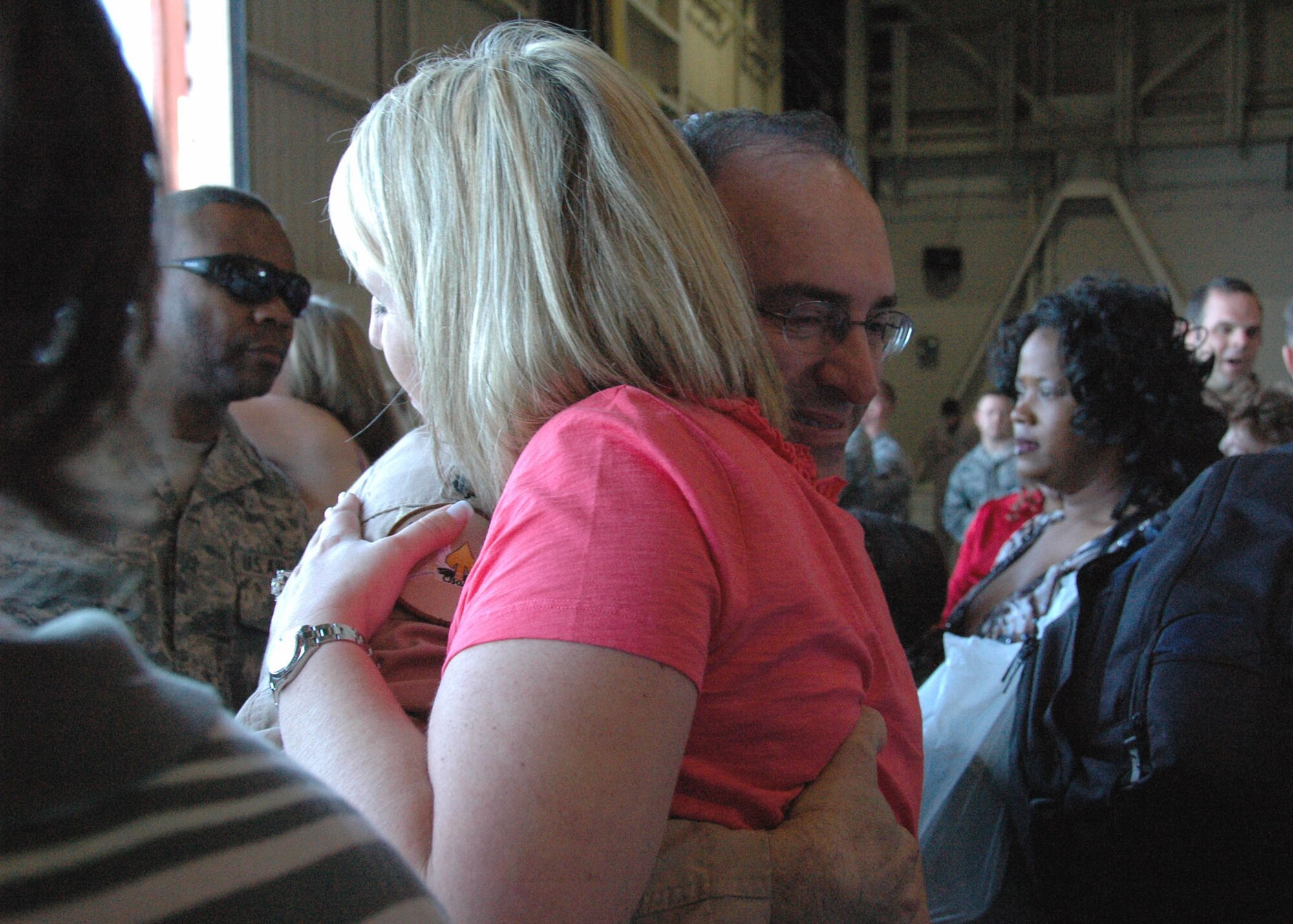 Air Force Reserve Lt. Col. Christopher Snider from Duke Field's 711th Special Operations Squadron hugs his wife Christina inside a hangar at Hurlburt Field April 6. Known as Operation Homecoming, the event reunited returning Duke Field and Hurlburt warfighters with family, fellow Airmen and local civic leaders following lengthy deployments in support of operations in Southwest Asia. (U.S. Air Force photo/Dan Neely)