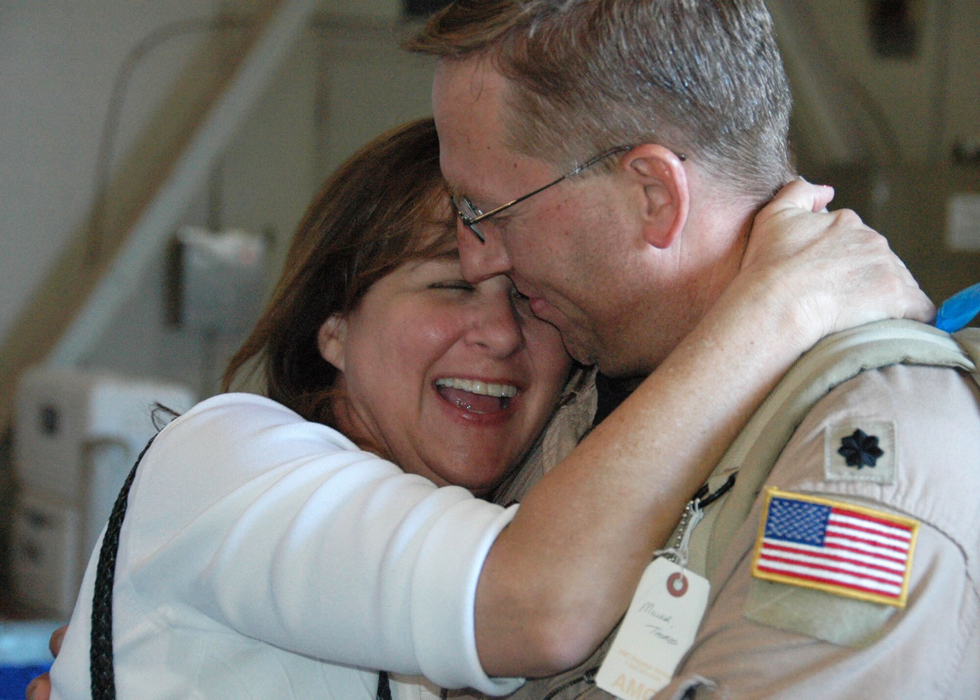 Air Force Reserve Lt. Col. Tom Miller, 919th Special Operations Wing, receives a welcome home hug from his wife Linda inside a hangar at Hurlburt Field April 6. Known as Operation Homecoming, the event reunited returning Duke Field and Hurlburt warfighters with family, fellow Airmen and local civic leaders following lengthy deployments in support of operations in Southwest Asia. (U.S. Air Force photo/Dan Neely)