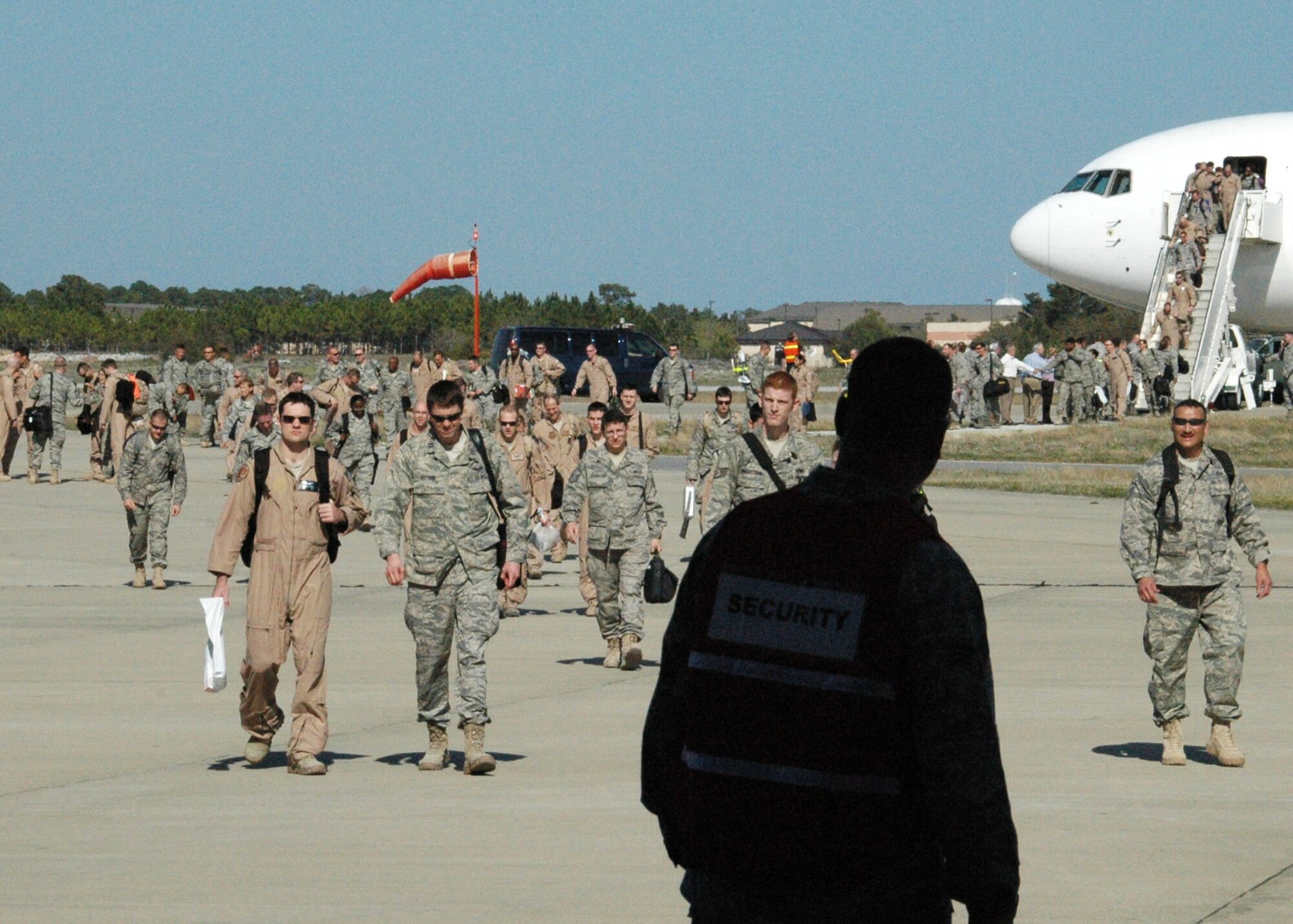 Returning Reservists from Duke Field's 919th Special Operations Wing, along with their active-duty counterparts from Hurlburt Field, deplane and cross Hurlburt's tarmac toward awaiting family members April 6.  Known as Operation Homecoming, the Hurlburt event reunited returning warfighters with family, fellow Airmen and local civic leaders following lengthy deployments in support of operations in Southwest Asia. (U.S. Air Force photo/Adam Duckworth)