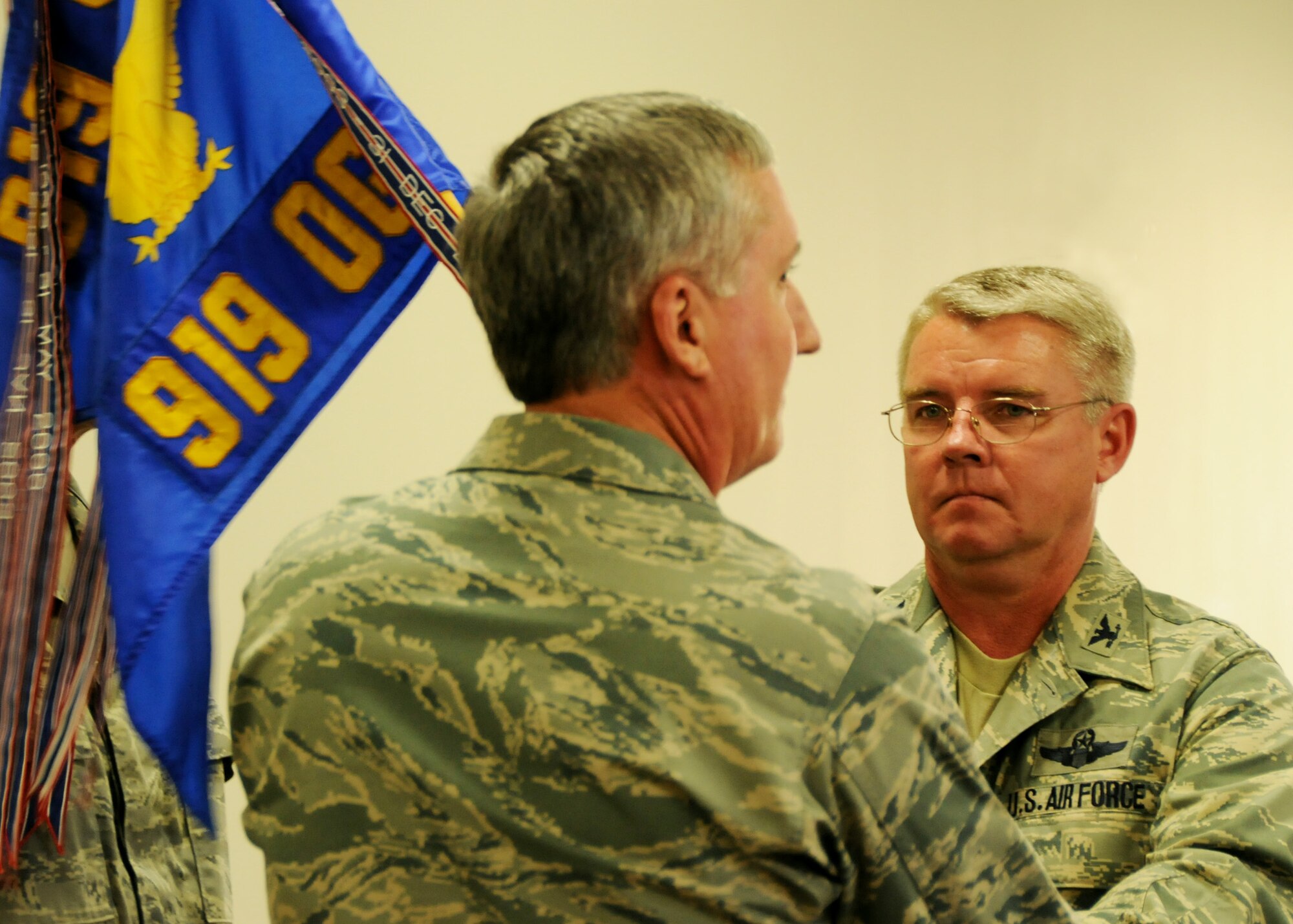 Col. Donald Buckley (right) receives the 919th Operations Group guidon from Col. Jon Weeks, 919th Special Operations Wing commander, during Colonel Buckley's assumption of command ceremony April 10 at Duke Field.   As the new 919th OG commander, Colonel Buckley reports to the wing commander on all operational matters for Reserve squadrons operating Air Force Reserve Command-owned MC-130E Combat Talon I aircraft, active-duty-owned U-28 aircraft and MQ-1 Predator remotely piloted aircraft. (U.S. Air Force photo/Tech. Sgt. Samuel King Jr.)