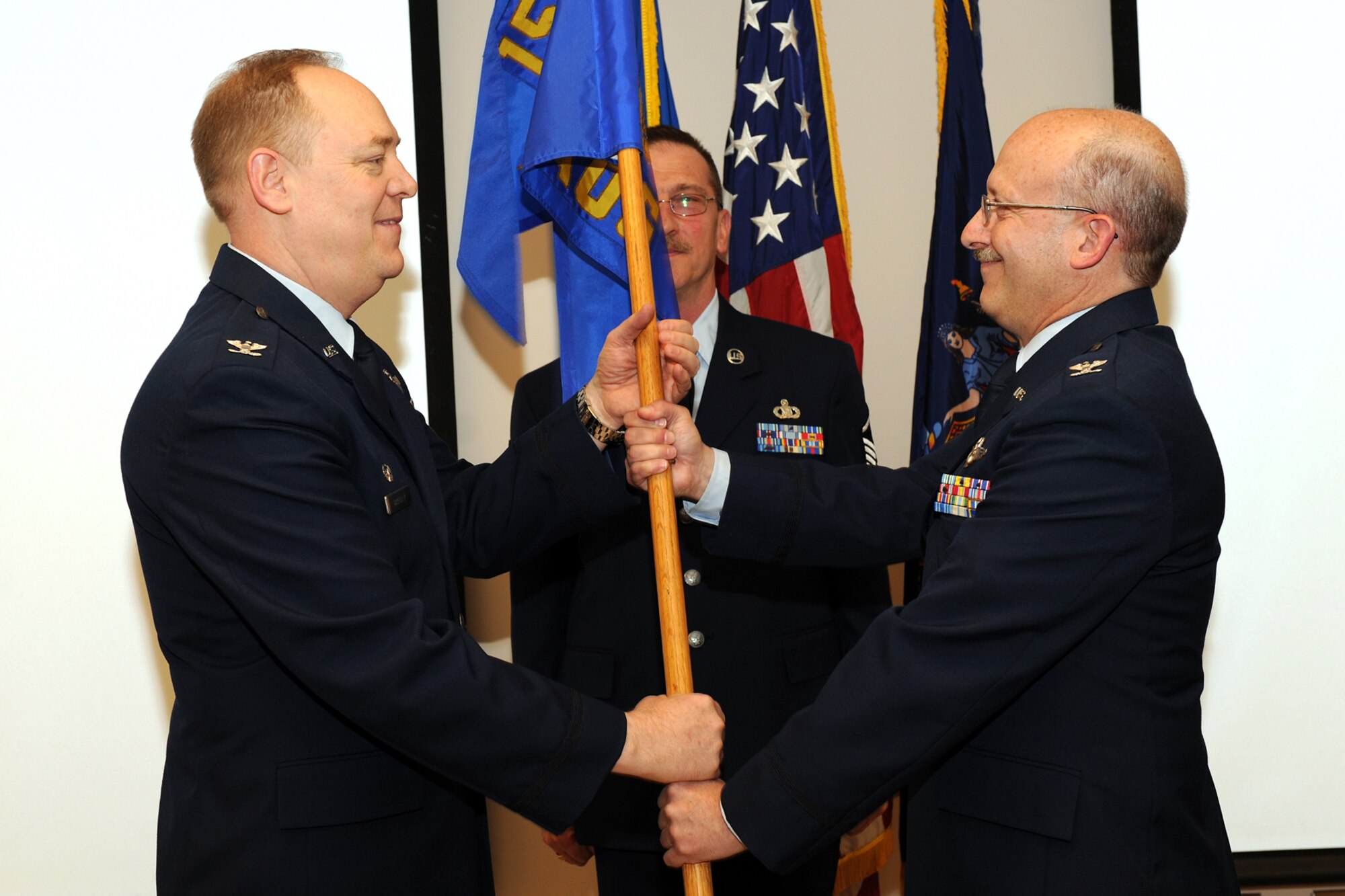 Outgoing 152nd Air Operations Group Commander, Colonel Kevin Brown relinquishes the Guideon to 174th Fighter Wing Commander Colonel Kevin Bradley. Colonel Brown handed over the 152AOG to Colonel (sel) Mark Murphy during the April UTA.(US Air Force photo by Staff Sgt James N. Faso II/RELEASED)