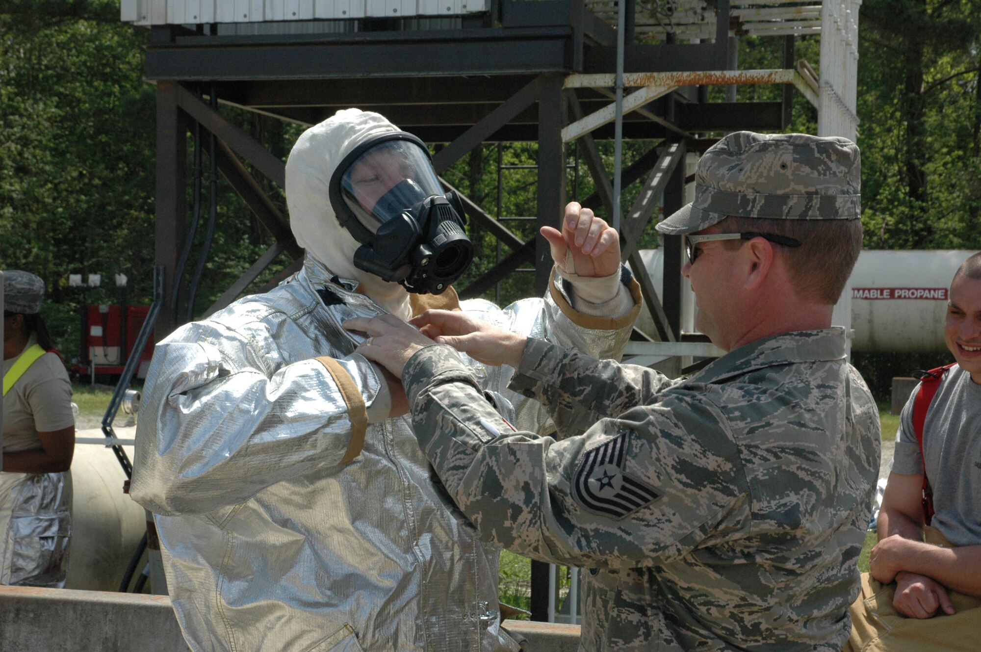 Seventeen firefighters assigned to 315th Civil Engineering Flight donned their aircraft rescue suits for mandatory daytime live fire training Saturday, April 10 at Charleston Air Force Base, S.C. Sweeping through the ‘burn building’ in teams of four, the firefighters were required to extinguish a simulated kitchen fire burning up to 700 degrees before backing out of the structure. Each run-through also allowed the firefighters additional training on the fire rescue truck by repacking the hose and returning the truck to a ‘serviceable’ condition. (U.S. Air Force photo by Senior Airman Dani Shea / Released)