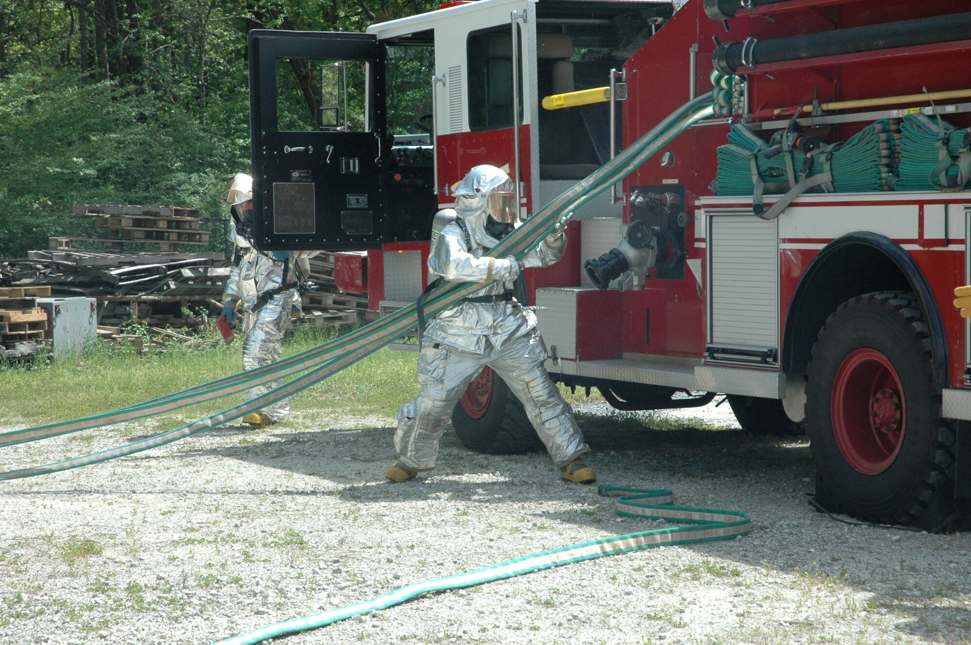 Seventeen firefighters assigned to 315th Civil Engineering Flight donned their aircraft rescue suits for mandatory daytime live fire training Saturday, April 10 at Charleston Air Force Base, S.C. Sweeping through the ‘burn building’ in teams of four, the firefighters were required to extinguish a simulated kitchen fire burning up to 700 degrees before backing out of the structure. Each run-through also allowed the firefighters additional training on the fire rescue truck by repacking the hose and returning the truck to a ‘serviceable’ condition. (U.S. Air Force photo by Senior Airman Dani Shea / Released)