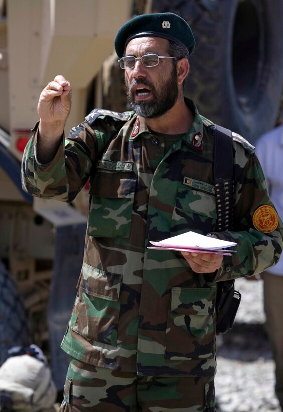 Col. Ali Ahmad, an Afghan National Army cultural and religious advisor, speaks to a crowd of people at Nawa’s first-ever ANA recruiting and information event April 12.  More than 60 people attended the event at Patrol Base Jaker to hear about the benefits of military service.