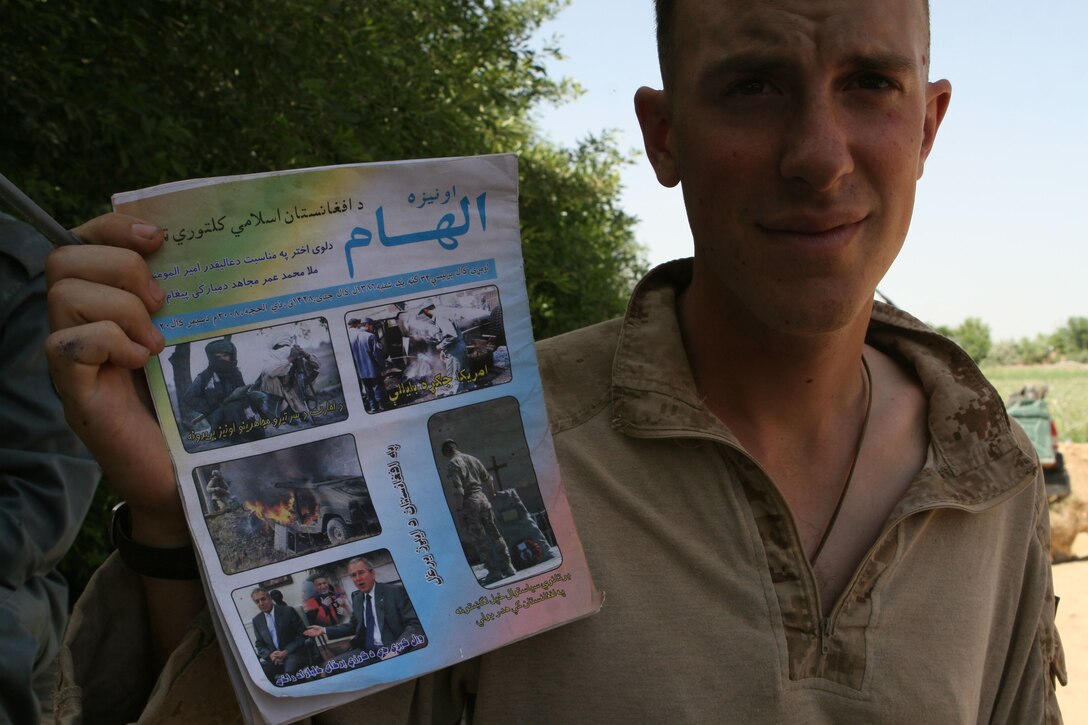Lance Cpl. Richard A. Louke a mortarman with 81 mm Mortar Platoon, Weapons Company, 1st Battalion, 6th Marine Regiment holds a Taliban pamphlet that was left near their guard post in Marjah, Afghanistan, April 13. Marines and Afghan National Army soldiers with 1/6 are taking part in the Marjah Accelerated Agricultural Transition program, which is a project aimed at facilitating the transition from illicit to licit crops.