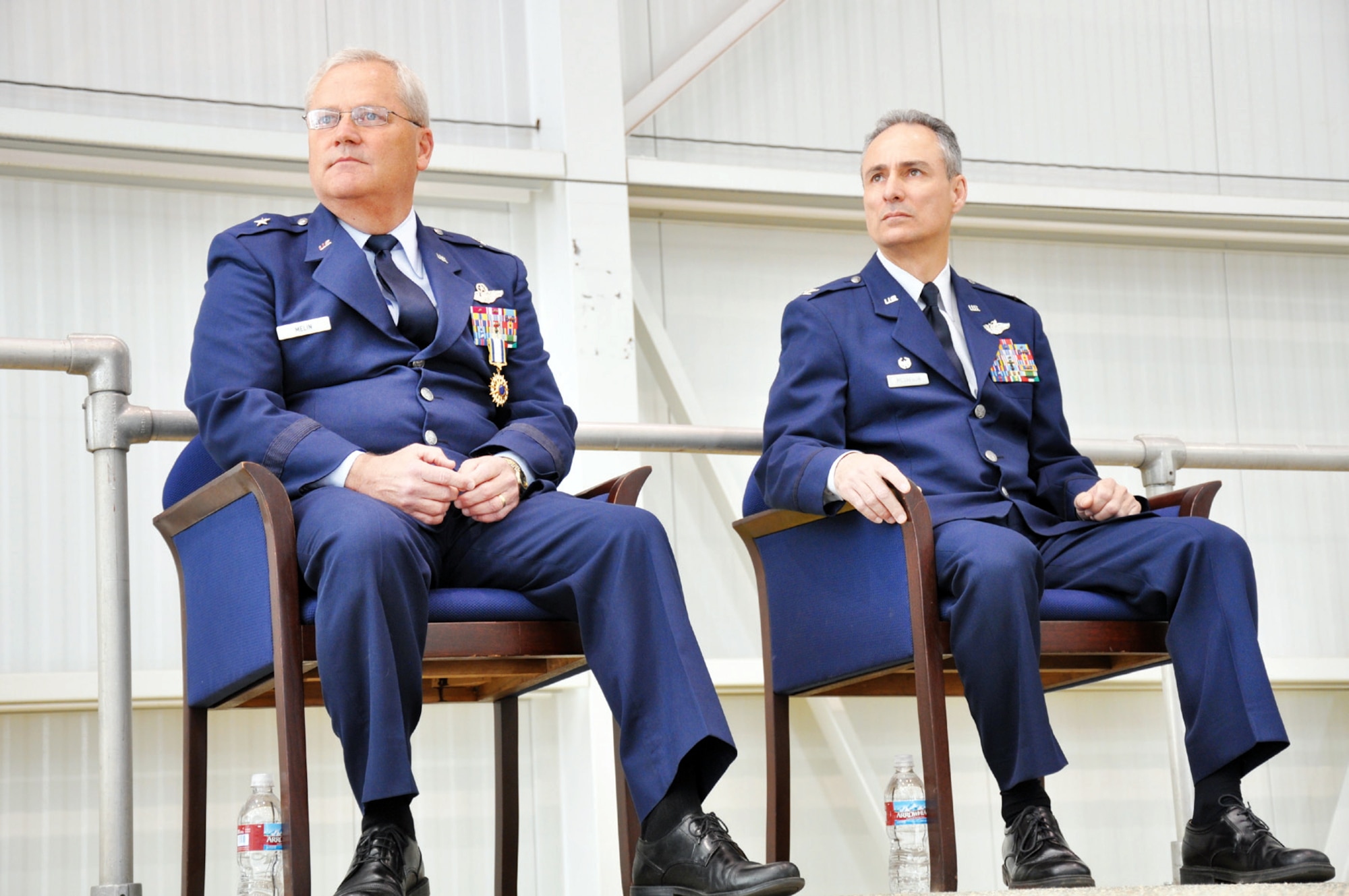 Brig. Gen. James Melin (left) and Col. Karl McGregor listen to Maj. Gen. Eric Crabtree speak at the opening of the change of command ceremony March 27. (U.S. Air Force photo by Senior Airman Patrick Cabellon)