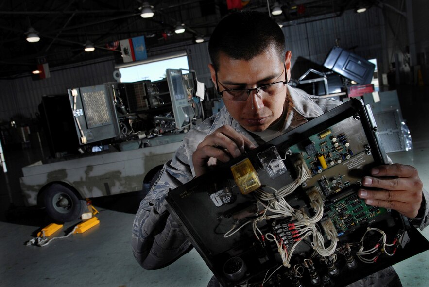 U.S. Air Force Senior Airman Tony Vitela, an aerospace ground equipment technician assigned to the 452nd Maintenance Squadron, inspects an electrical circuit card of an A/ M32-86 generator at March Air Reserve Base. (U.S. Air Force photo  by Val Gempis)
