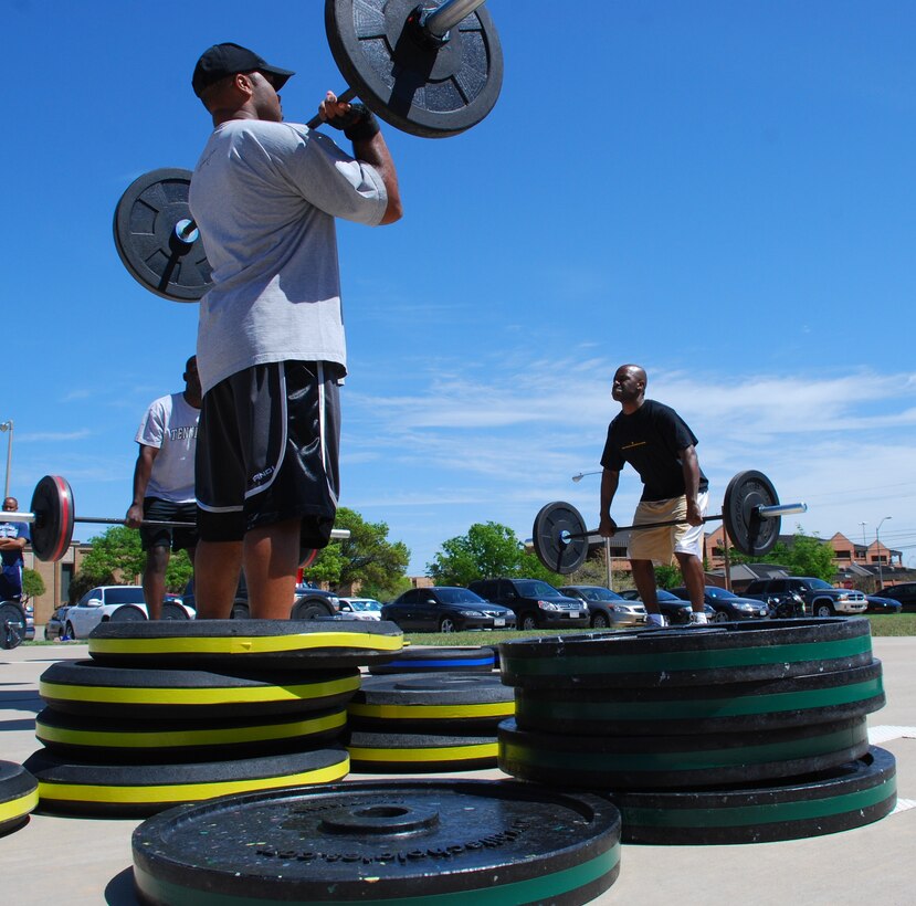 Members of Team Sheppard practice Olympic-style weight lifting to help build power and explosion during their workout in the Combat Fit program offered by the Health and Wellness Center April 9, 2010.  Combat Fit members have performed weight lifting, cardio workouts, plyometrics and other types of exercises to improve combat readiness.  (U.S. Air Force photo/Tech Sgt. Vernon Cunningham)