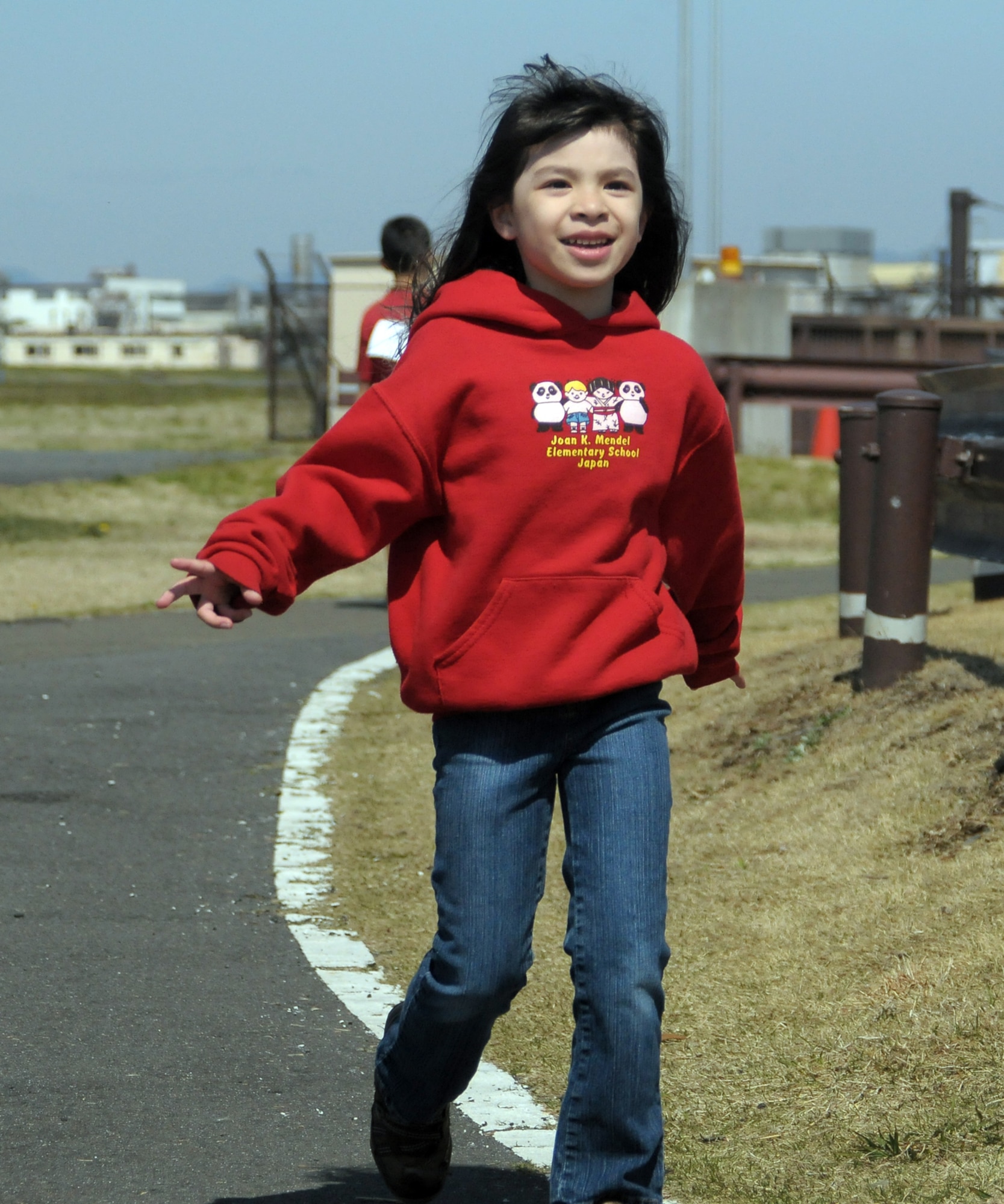 YOKOTA AIR BASE, Japan -- Alyssa Montiel, 2nd grader, runs as she finishes her 12th lap during the 2010 Jog/Walk-a-thon, April 8. The Jog/Walk-a-thon was held to raise money for Joan K. Mendel Elementary School. (U.S. Air Force photo/Airman 1st Class Katrina R. Menchaca)
