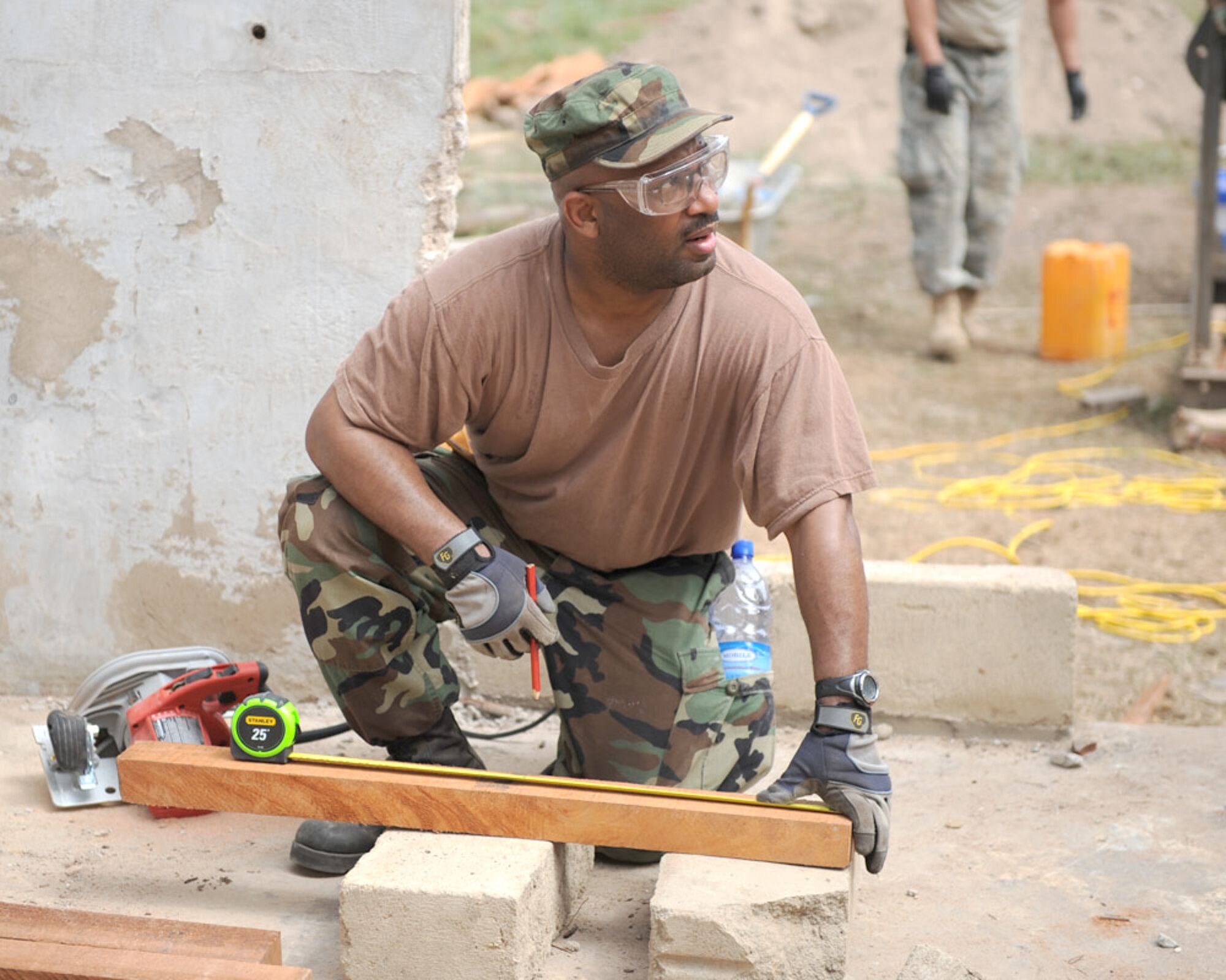 Staff Sgt. Marcel Prude measures a piece of lumber while working on a building project during a deployment with the Michigan Air National Guard’s 127th Civil Engineering Squadron to Accra, Ghana, April 11, 2010. The detachment of 127th CES Airmen is working on doing major renovations to a technical training building at the Akota air base in Ghana, along with a team from the North Dakota Air National Guard. North Dakota and Ghana are partners in the National Guard’s State Partnership Program, in which state National Guards partner with emerging nations. Michigan recently became partners with Liberia, which borders Ghana in western Africa. (U.S. Air Force photo by MSgt Terry Atwell)