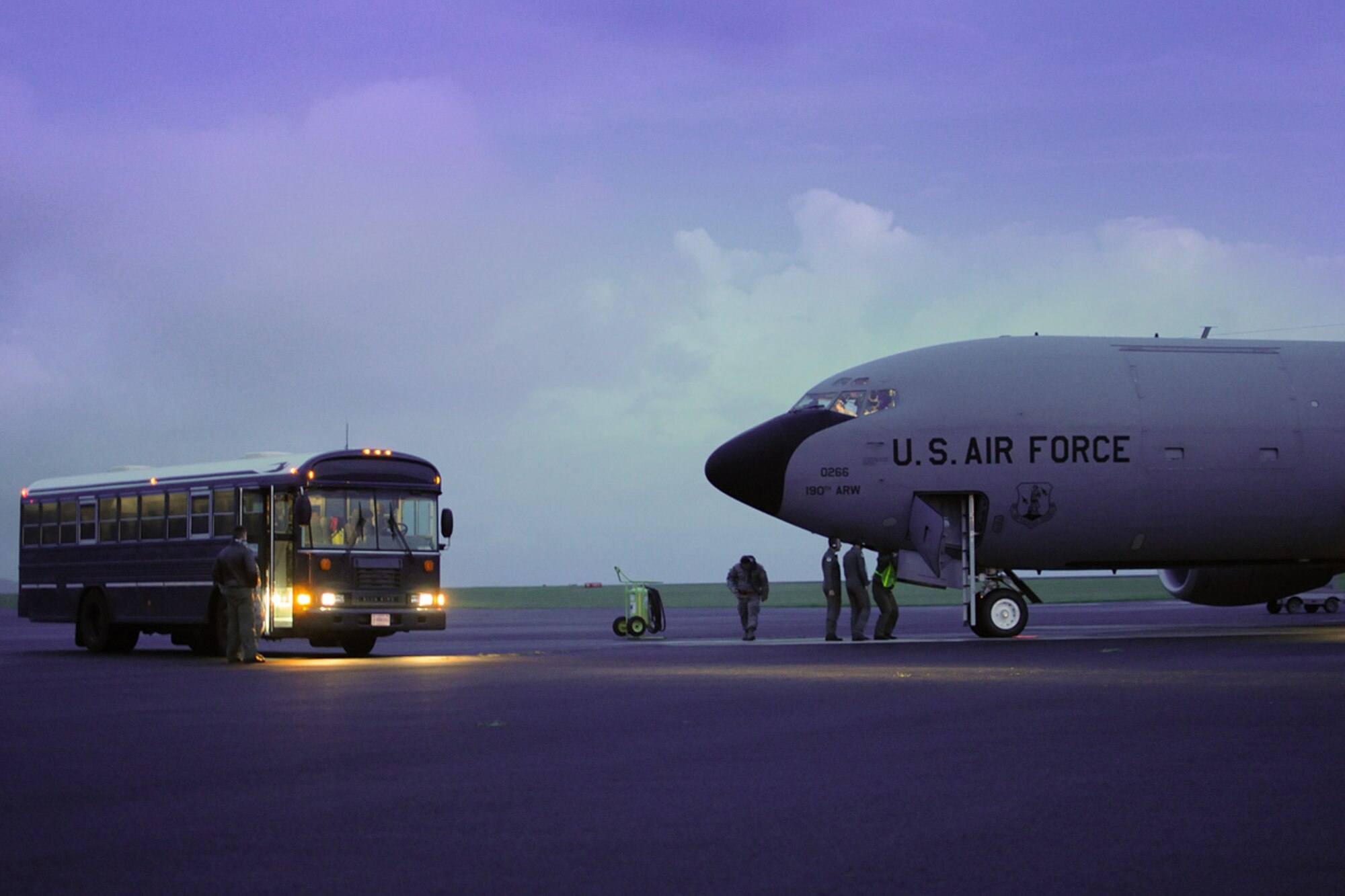 A detachment of Airmen from the 127th Civil Engineering Squadron, Michigan Air National Guard, wait on a bus prior to boarding a KC-135 Stratotanker in the early morning hours of April 8, 2010, at Lajes Field in the Azores Islands, Portugal. The Airmen were awaiting transportation to Accra, Ghana, for a two-week deployment. (U.S. Air Force photo by MSgt. Terry Atwell)