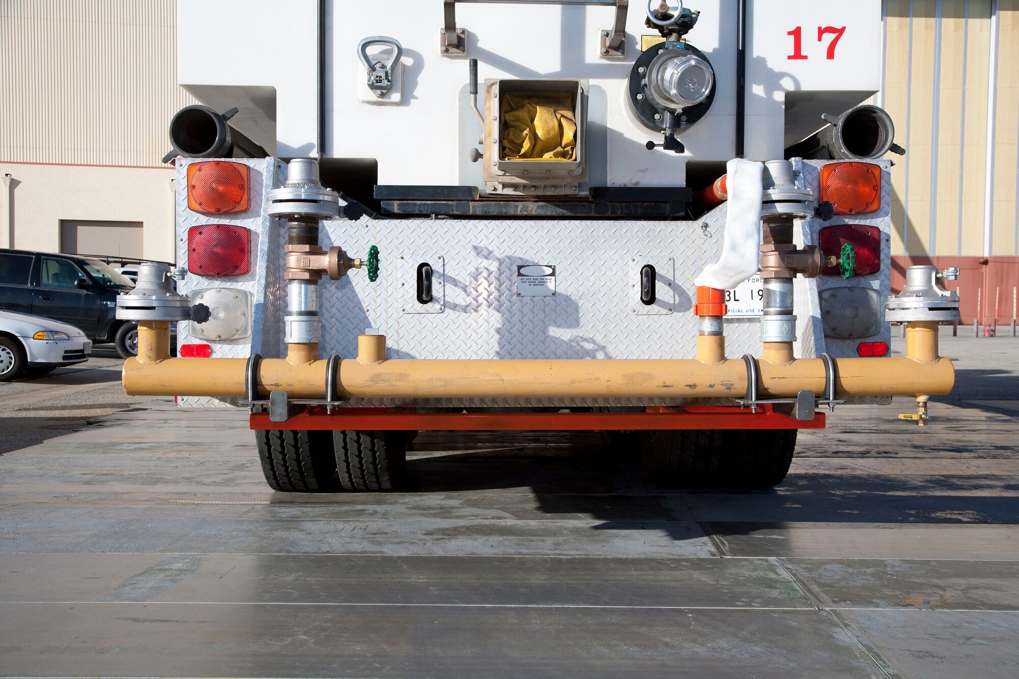 A custom spray bar built by Edwards AFB engineers is mounted to a water tanker truck to wet a runway.   The spray bar was built specifically for wet runway testing and was used in the Block 20 Global Hawk wet runway testing in April at Edwards.  (Air Force photo by Chad Bellay) 