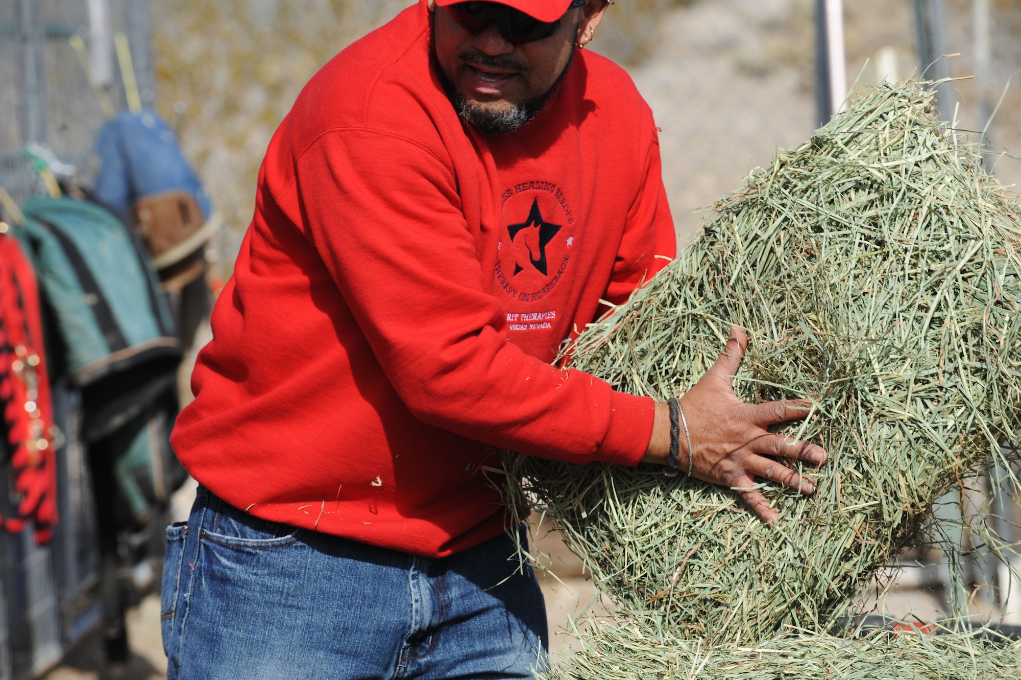 Kim Tanner, retired U.S. Army transportation specialist, bails hay at Spirit Therapies in Las Vegas, Nev., as part of the Horses Healing Heroes program. The program is designed to serve both active-duty military and veterans who have been diagnosed with physical and/or mental challenges.  
(U.S. Air Force photo/ Master Sgt. Kevin J. Gruenwald)