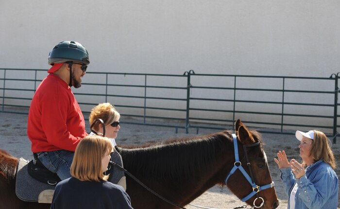 With help from volunteers, Laurie Willmott, owner and founder of Spirit Therapies in Las Vegas, Nev., teaches Kim Tanner, retired U.S. Army transportation specialist, the art of horseback riding. Mr. Tanner sustained severe injuries after being struck by an improvised explosive device in Iraq in 2005.
(U.S. Air Force photo/ Master Sgt. Kevin J. Gruenwald)
