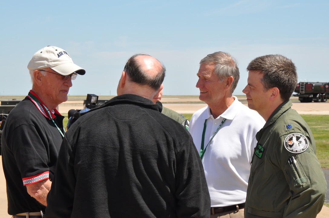 A Vietnam-era F-105 pilot and prisoner of war, retired Col. Tom Norris (white cap), shares his story with former members of the 469th Tactical Fighter Squadron and 469th Flying Training Squadron Commander Lt. Col. Richard Griffin (right) during the 469th TFS reunion here Friday. (U.S. Air Force photo/1st Lt. Brittany Martin)