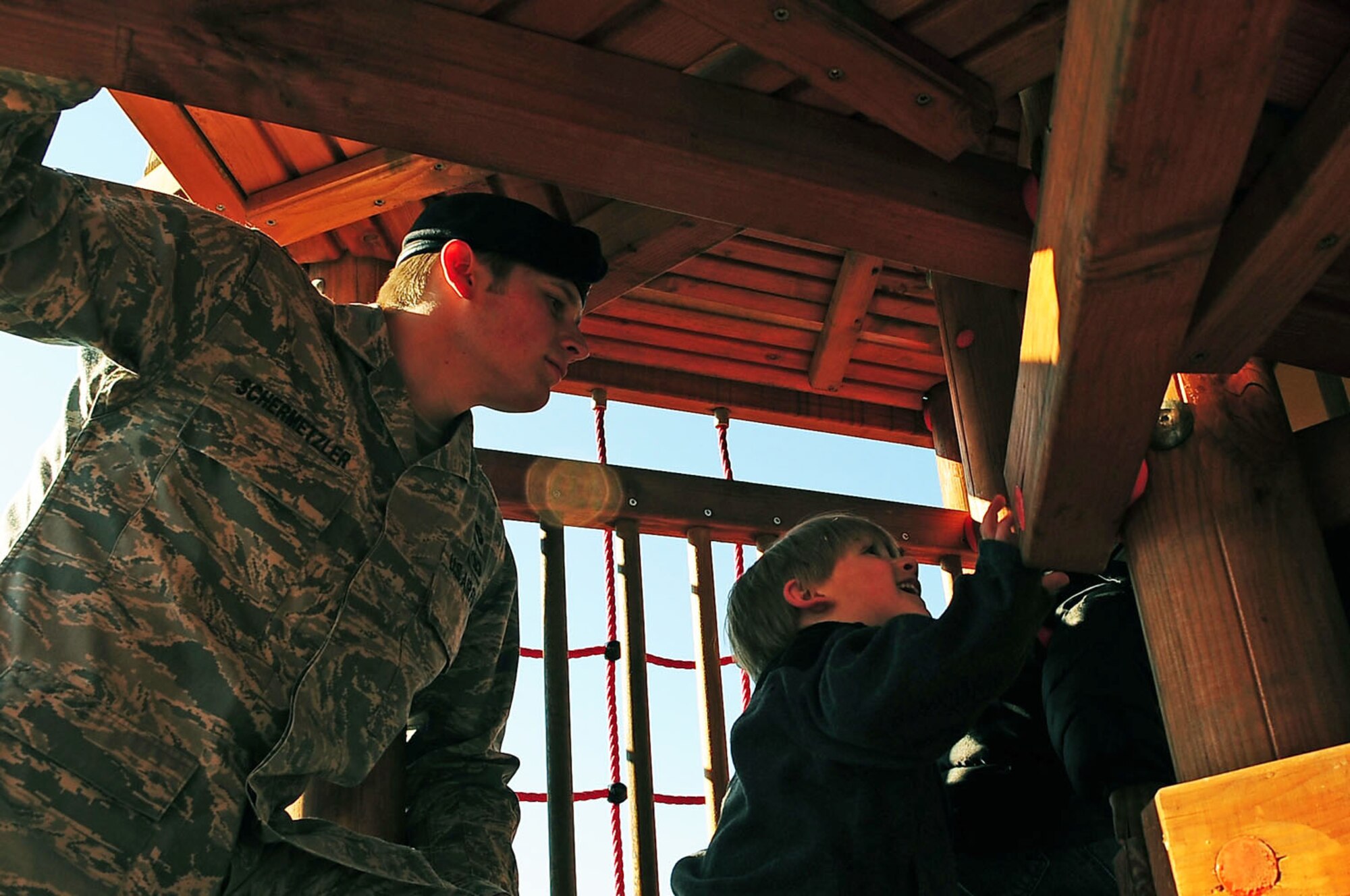 Senior Airman Joseph Schermetzkr follows children up a tower on the playground during the child development center's "Boot Camp Week" April 7, 2010, at the child development center at Rose Barracks, Vilseck Military Community, Germany. "Boot Camp Week" gave servicemembers' children an opportunity to experience some military norms such as physical training, first aid, land navigation and tactical vehicle familiarization in support of the Department of Defense's Month of the Military Child. Airman Schermetzkr is a 2nd Air Support Operations Squadron tactical air control party member. (U.S. Air Force photo/Senior Airman Tony R. Ritter)