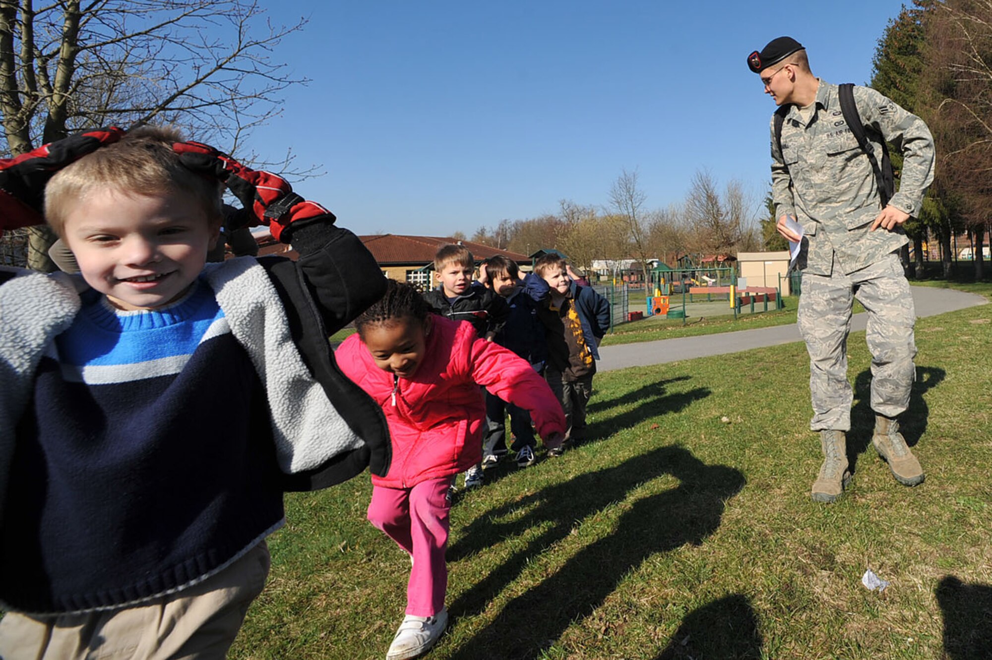 Airman 1st Class Brian Crabill leads a group of children on a run during the child development center's "Boot Camp Week" April 7, 2010, at the child development center at Rose Barracks, Vilseck Military Community, Germany. "Boot Camp Week" gave servicemembers' children an opportunity to experience some military norms such as physical training, first aid, land navigation and tactical vehicle familiarization in support of the Department of Defense's Month of the Military Child. Airman Crabill is a 2nd Air Support Operations Squadron tactical air control party member. (U.S. Air Force photo/Senior Airman Tony R. Ritter)