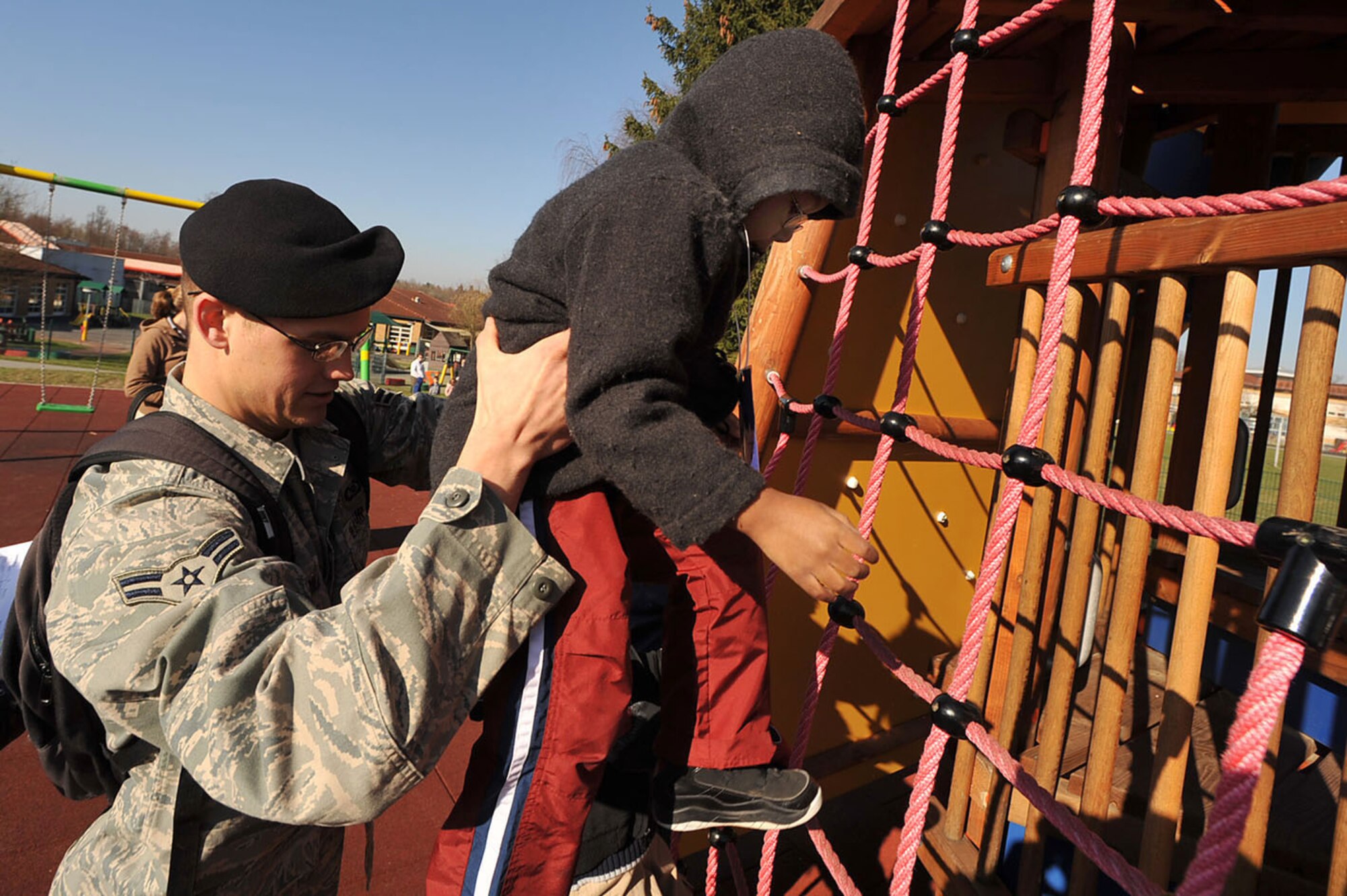 Airman 1st Class Brian Crabill gives a child a boost up on the playground during "Boot Camp Week" April 7, 2010, at the child development center at Rose Barracks, Vilseck Military Community, Germany. "Boot Camp Week" gave servicemembers’ children an opportunity to experience some military norms such as physical training, first aid, land navigation and tactical vehicle familiarization in support of the Department of Defense's Month of the Military Child. Airman Crabill is a 2nd Air Support Operations Squadron tactical air control party member. (U.S. Air Force photo/Senior Airman Tony R. Ritter) 