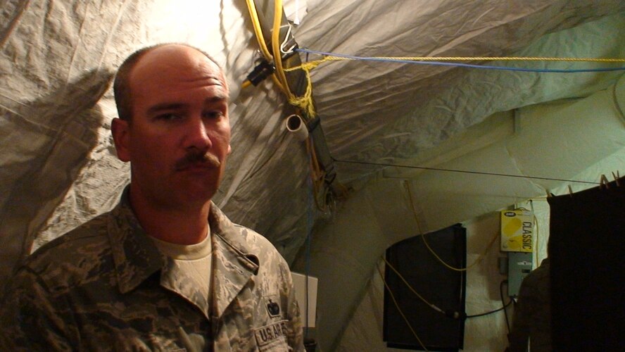 PORT-AU-PRINCE, Haiti -- Tech. Sgt. Jonothon McGuire, 823rd Expeditionary Security Forces Squadron “wake-up sergeant," stands here in a tent near the Toussaint L'Ouverture International Airport, Haiti, where the squadron has been deployed since January to provide security. (Contributed photo/RELEASED)