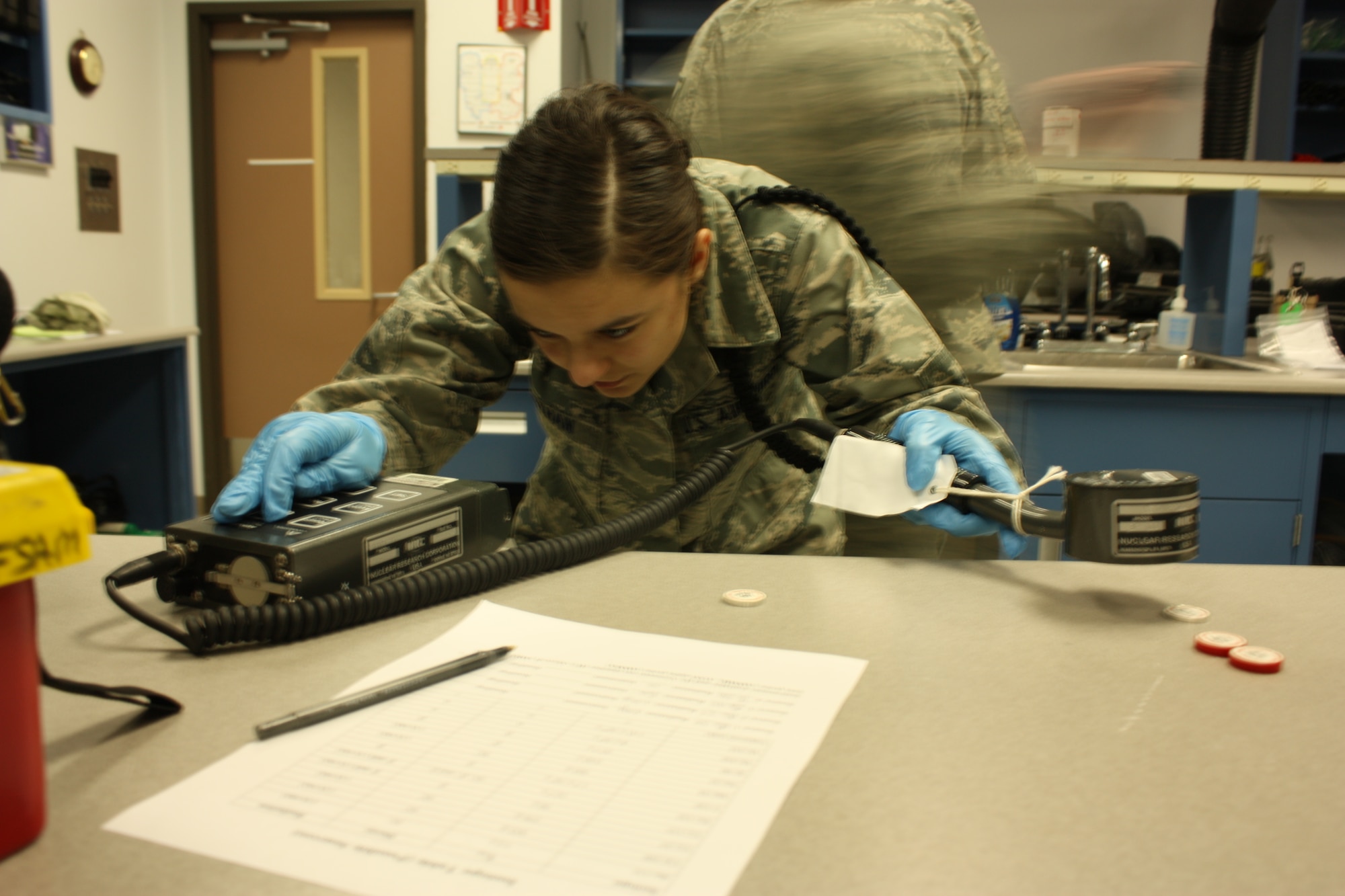 Before receiving Air Force occupational and environmental health assignments, both officers and enlisted personnel undergo many weeks of specialized training, taught by the USAF School of Aerospace Medicine's Occupational and Enviromental Health Department (USAFSAM/OED). Here, a student in the Bioenvironmental Engineering Apprentice course measures the radioactivity level of a sample during training at the school. (USAF photo by Erik Brazones)