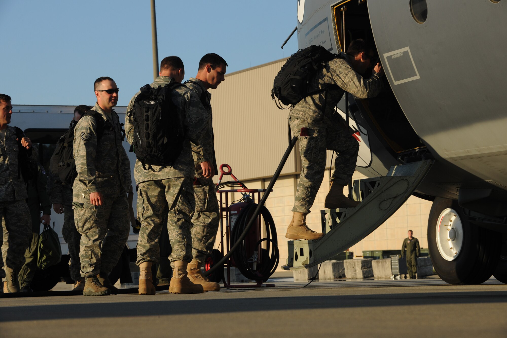 MOODY AIR FORCE BASE, Ga. -- Members from the 38th and 41st Rescue Squadrons board a C-130E Hercules aircraft here April 12. The aircraft will be taking the members to Davis-Monthan Air Force Base, Ariz., to participate in exercise Angel Thunder, a multinational personnel recovery exercise. (U.S. Air Force photo by Airman 1st Class Benjamin Wiseman/RELEASED)