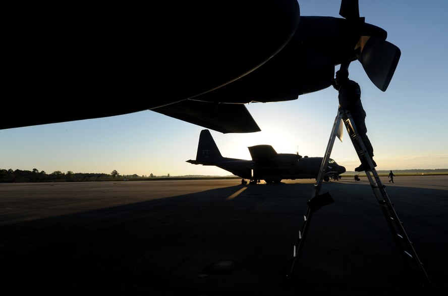 MOODY AIR FORCE BASE, Ga. -- Staff Sgt. David Poe, 71st Rescue Squadron crew chief, inspects the intake and exhaust of a C-130E Hercules aircraft here April 12. Sergeant Poe inspected all four engines before flight to ensure there was no debris inside. (U.S. Air Force photo by Airman 1st Class Benjamin Wiseman/RELEASED)  