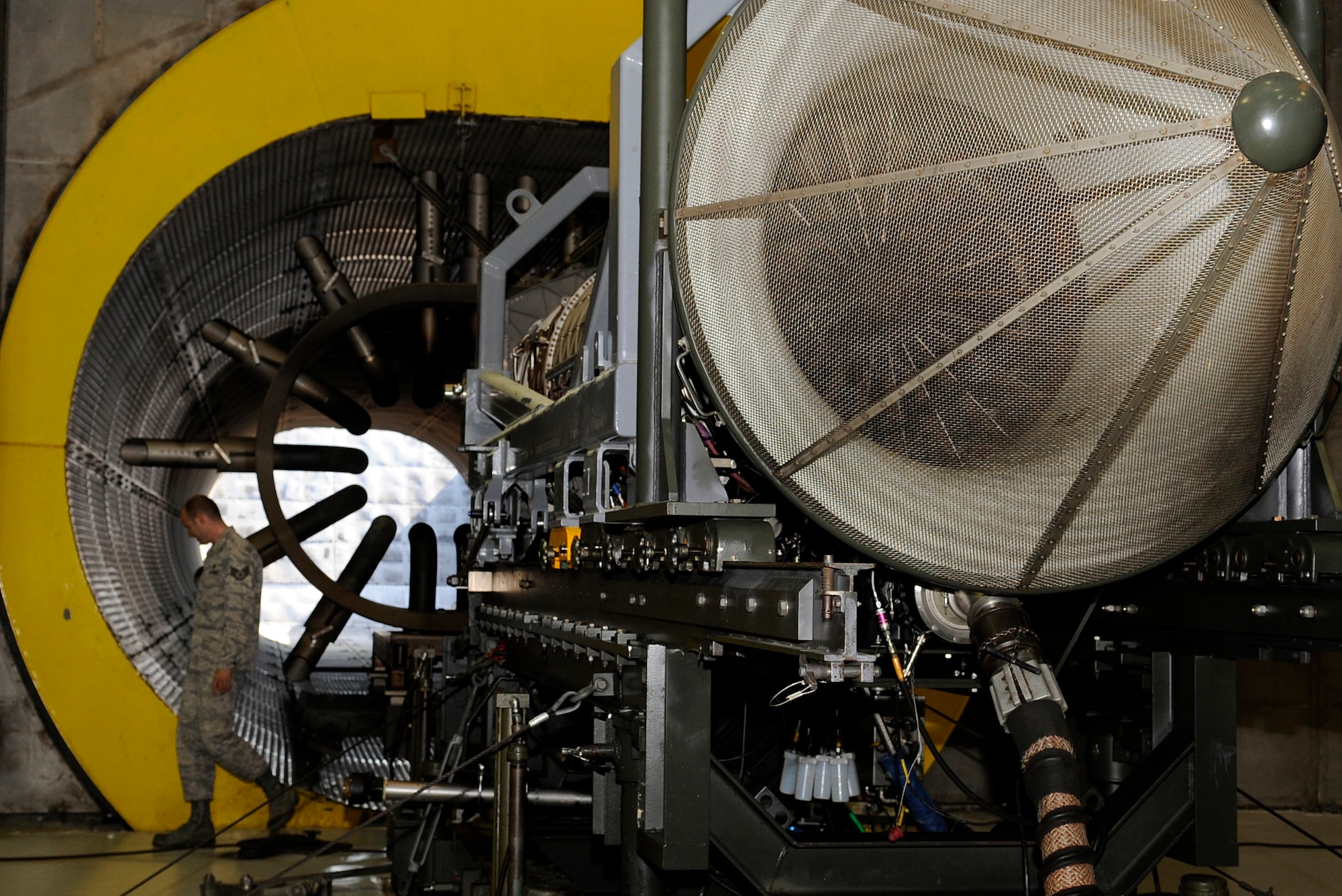 LANGLEY AIR FORCE BASE, Va. - Staff Sgt. Arik Wexler inspects the hangar during a foreign object debris walk in the hush house April 9. The hush house can facilitate uninstalled engines or entire jets using a modular track system. (U.S. Air Force photo/Airman 1st Class Gul Crockett)
