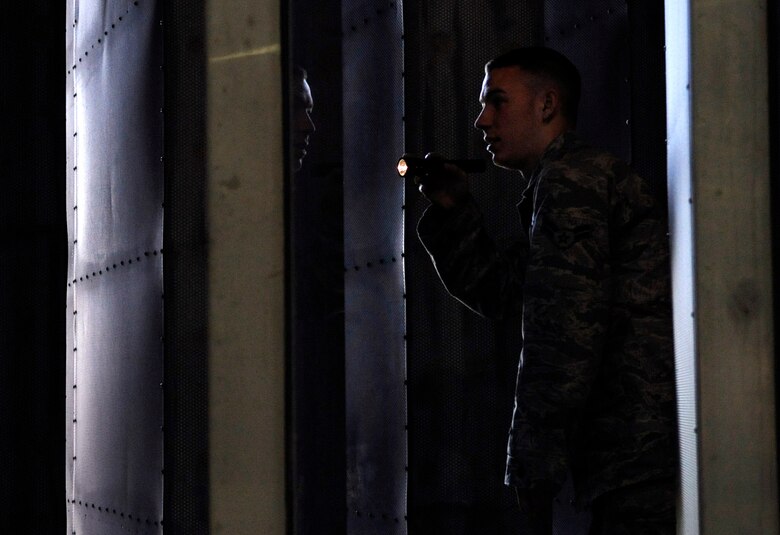 LANGLEY AIR FORCE BASE, Va. - Airman 1st Class Mathew Santianna inspects ventilation baffles during a foreign object debris walk in the hush house April 9.  These inspections are critical in order to remove any objects that could damage the blades inside the engines. (U.S. Air Force photo/ Airman 1st Class Gul Crockett) 
