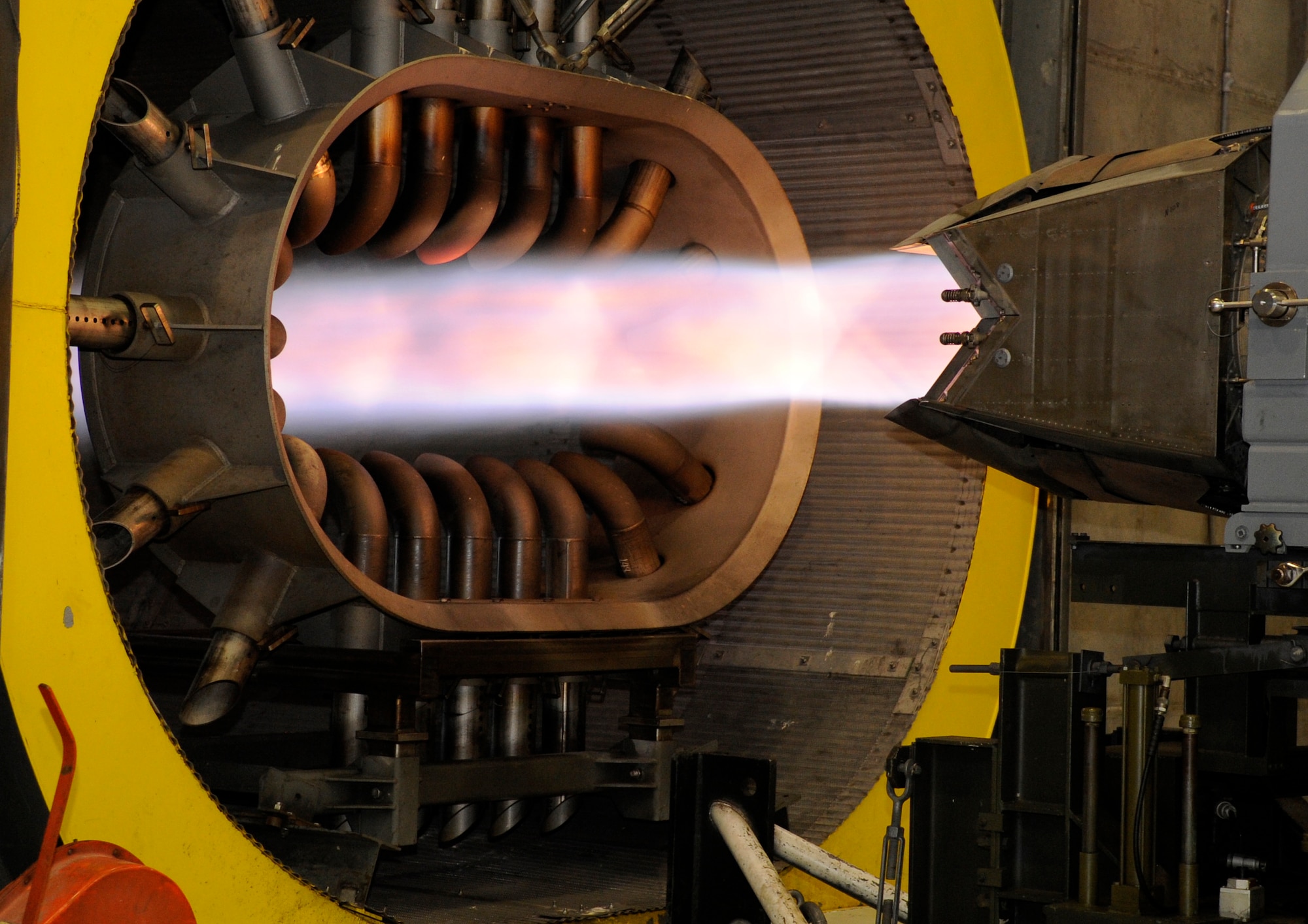 LANGLEY AIR FORCE BASE, Va. - A Pratt and Whitney F119-PW-100 engine is tested at maximum power at the hush house April 9. The tubes at the entrance to the wind tunnel absorb and distribute noise back into the building. (U.S. Air Force photo/ Airman 1st Class Gul Crockett)
