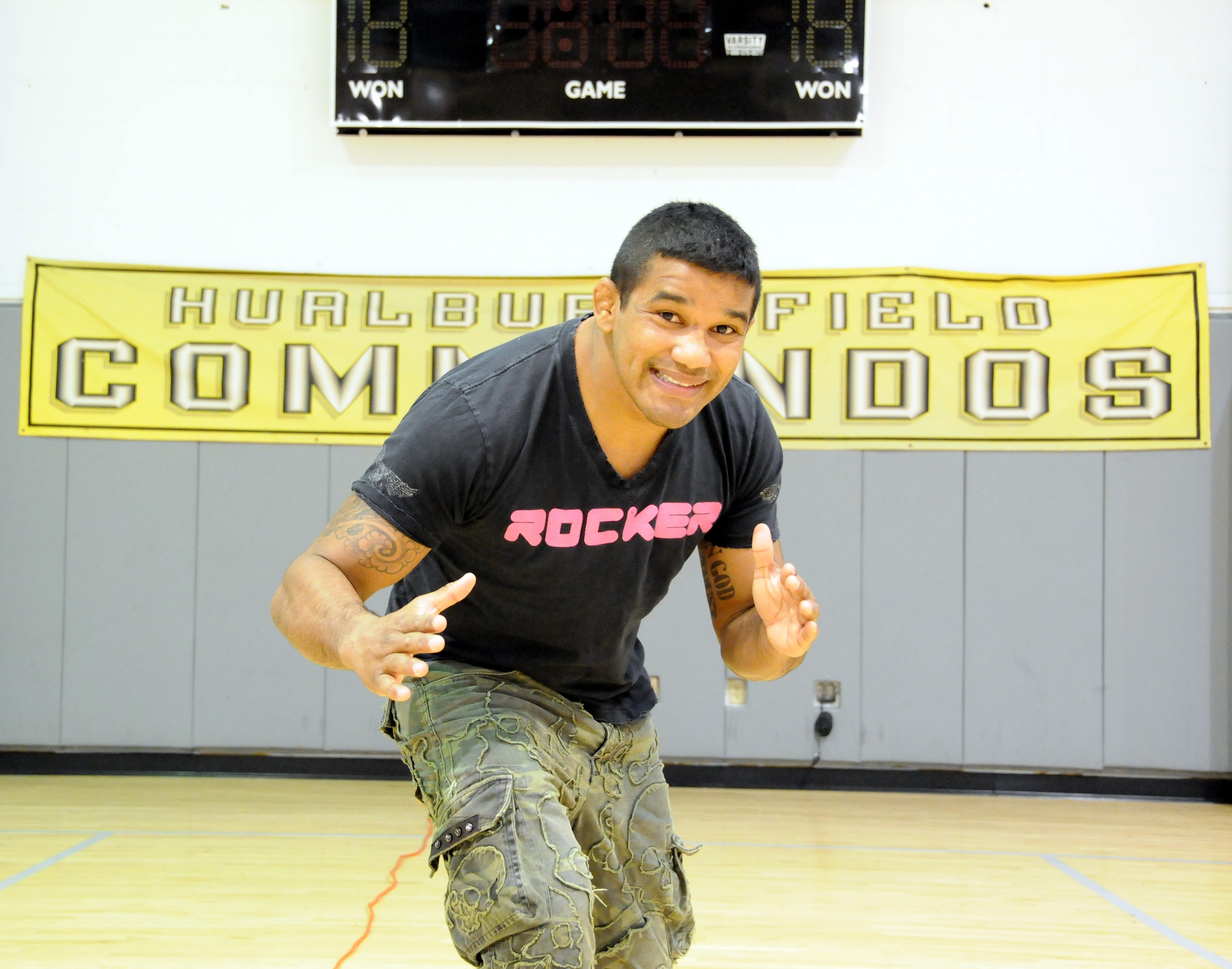 Hermes Franca, a Brazilian Jiu-Jitsu black belt champion, poses in front of a Hurlburt Field Commandos banner at the Aderholt Fitness Center at Hurlburt Field April 9. Mr. Franca visited with fans on base before giving a seminar at a new training center in Fort Walton Beach, Fla. (U.S. Air Force photo by Reuben Garcia) 