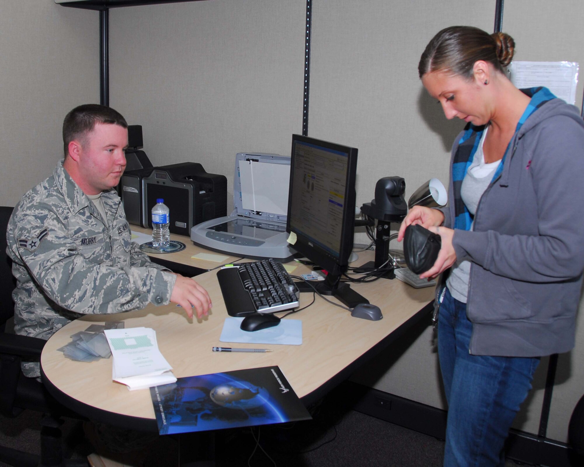 ALTUS AIR FORCE BASE, Okla. – Airman 1st Class Ryan Murry, 97th Force Support Squadron, creates a new identification card for Senior Airman Tabitha Paul, Air Force Reservist, April 10 at the Individual Ready Reserve Muster.  All reservists must attend an IRR muster annually in order to meet mobility requirements. (U.S. Air Force Photo/Senior Airman Marianne E. Lane) 