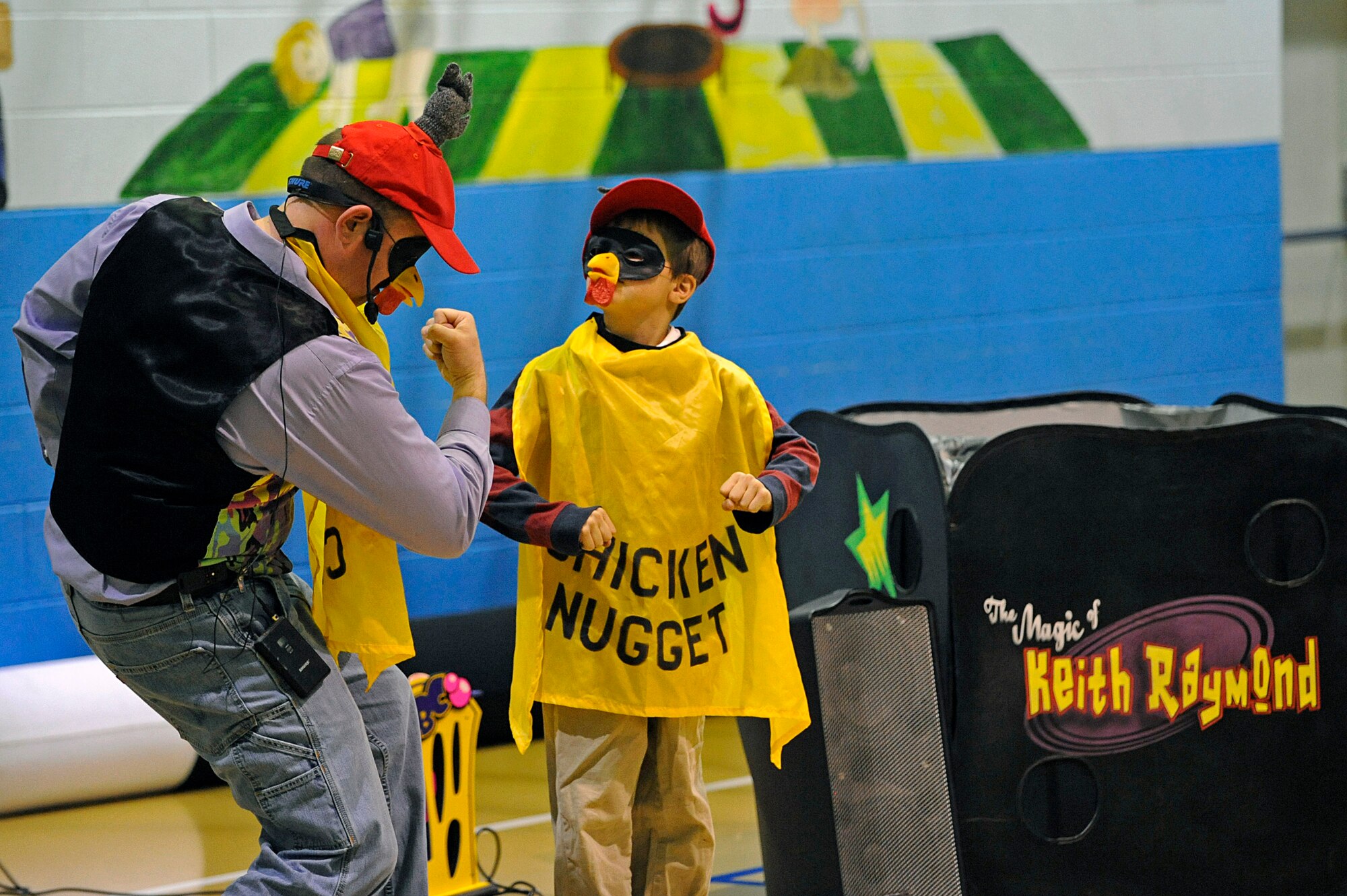 ELLSWORTH AIR FORCE BASE, S.D. -- Keith Raymond and a child pose to instructions from a compact disc in order to complete a magic trick, April 10. The Youth Center and Airman and Family Readiness Center sponsored the magic show in support of the Month of the Military Child. (U.S. Air Force photo/Airman 1st Class Matthew Flynn)