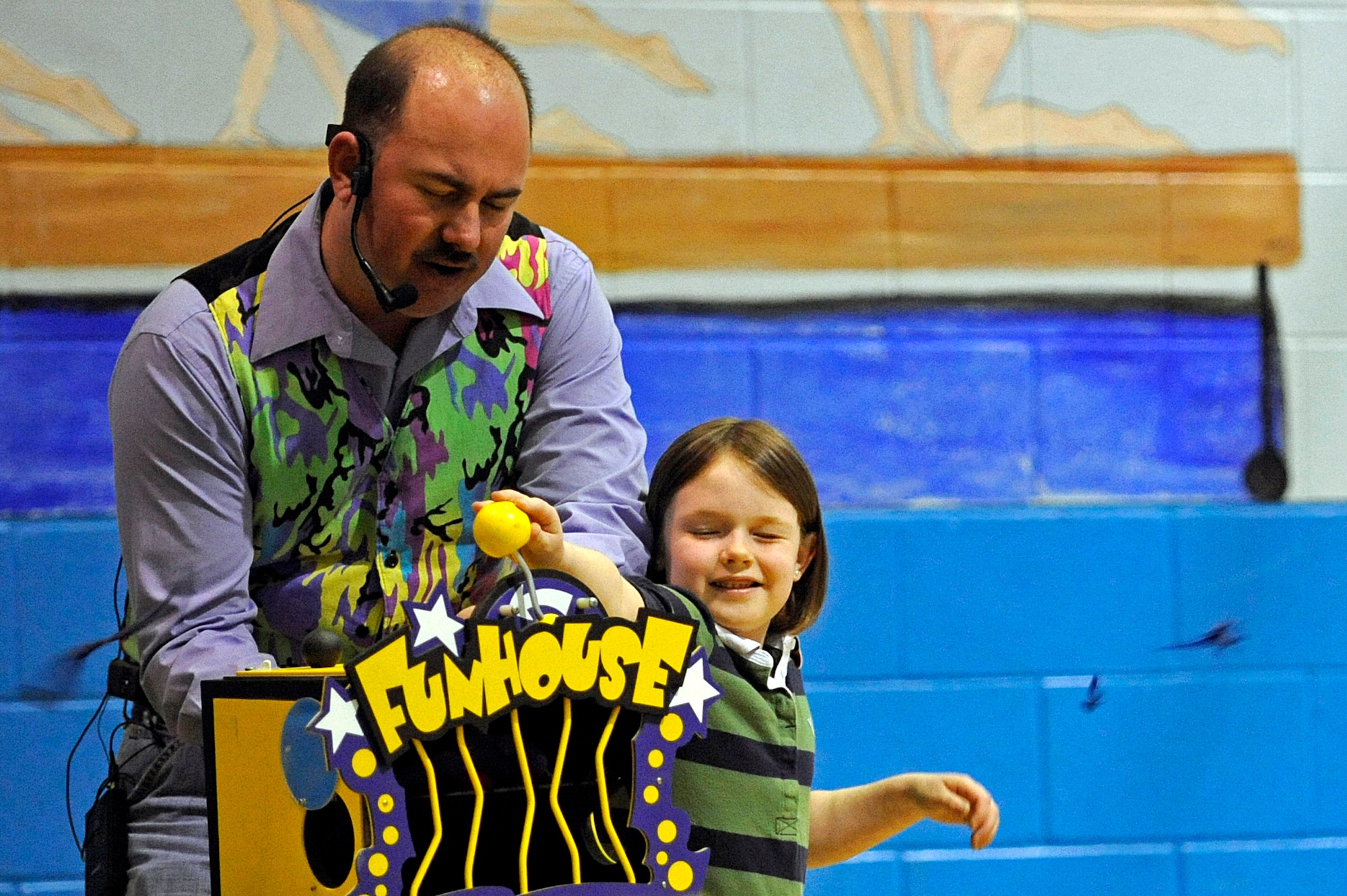 ELLSWORTH AIR FORCE BASE, S.D. -- Keith Raymond receives assistance on a magic trick from a child during a magic show, April 10.  The Youth Center and Airman and Family Readiness Center sponsored the event to celebrate the Month of the Military Child. (U.S. Air Force photo/Airman 1st Class Matthew Flynn)