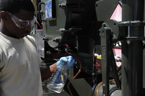 SEYMOUR JOHNSON AIR FORCE BASE, N.C. -- Senior Airman Laron Parks extracts a jet fuel sample to test for serviceability here April 8, 2010. The base injects a cleaning additive, plus 100, to the JP8 to help fuel burn cleaner, in turn reducing maintenance man-hours. Airman Parks is a 4th Logistics Readiness Squadron fuels lab technician who hails from Fayetteville. (U.S. Air Force photo/Airman 1st Class Gino Reyes)