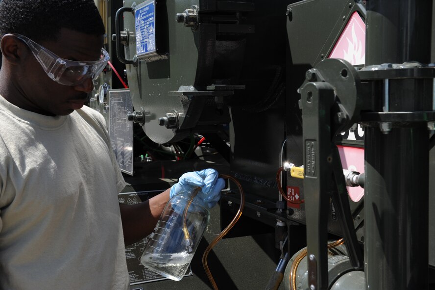 SEYMOUR JOHNSON AIR FORCE BASE, N.C. -- Senior Airman Laron Parks extracts a jet fuel sample to test for serviceability here April 8, 2010. The base injects a cleaning additive, plus 100, to the JP8 to help fuel burn cleaner, in turn reducing maintenance man-hours. Airman Parks is a 4th Logistics Readiness Squadron fuels lab technician who hails from Fayetteville. (U.S. Air Force photo/Airman 1st Class Gino Reyes)