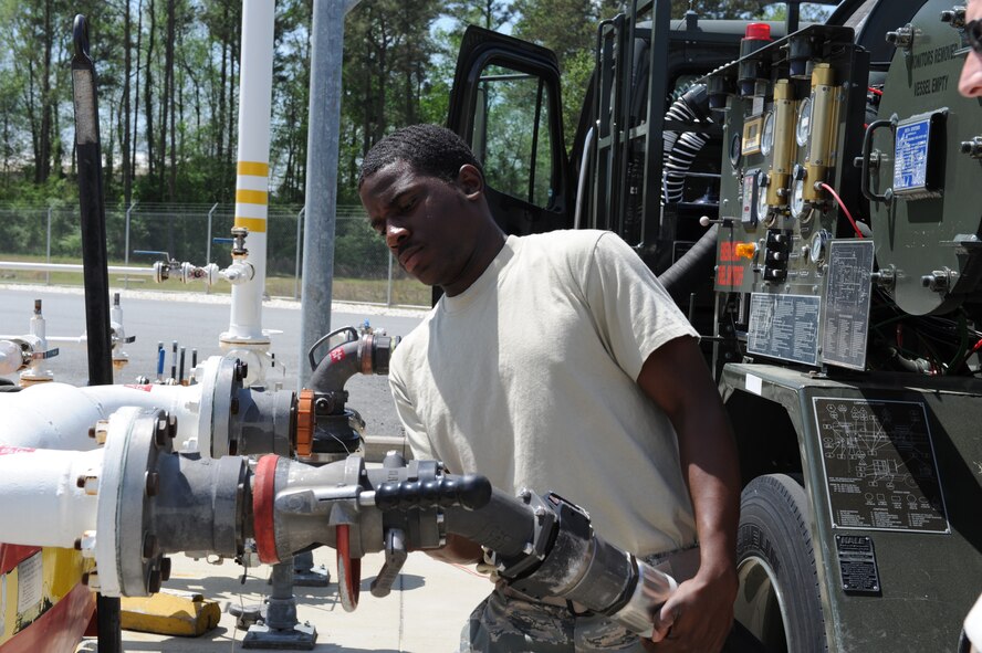 SEYMOUR JOHNSON AIR FORCE BASE, N.C. -- Senior Airman Laron Parks attaches a pump to a fuel tank here April 8, 2010. Fuels technicians are required to test all fuels dispensing equipment for serviceability on a daily basis. Airman Parks, 4th Logistic Readiness Squadron fuels lab technician, hails from Fayetteville. (U.S. Air Force photo/Airman 1st Class Gino Reyes)