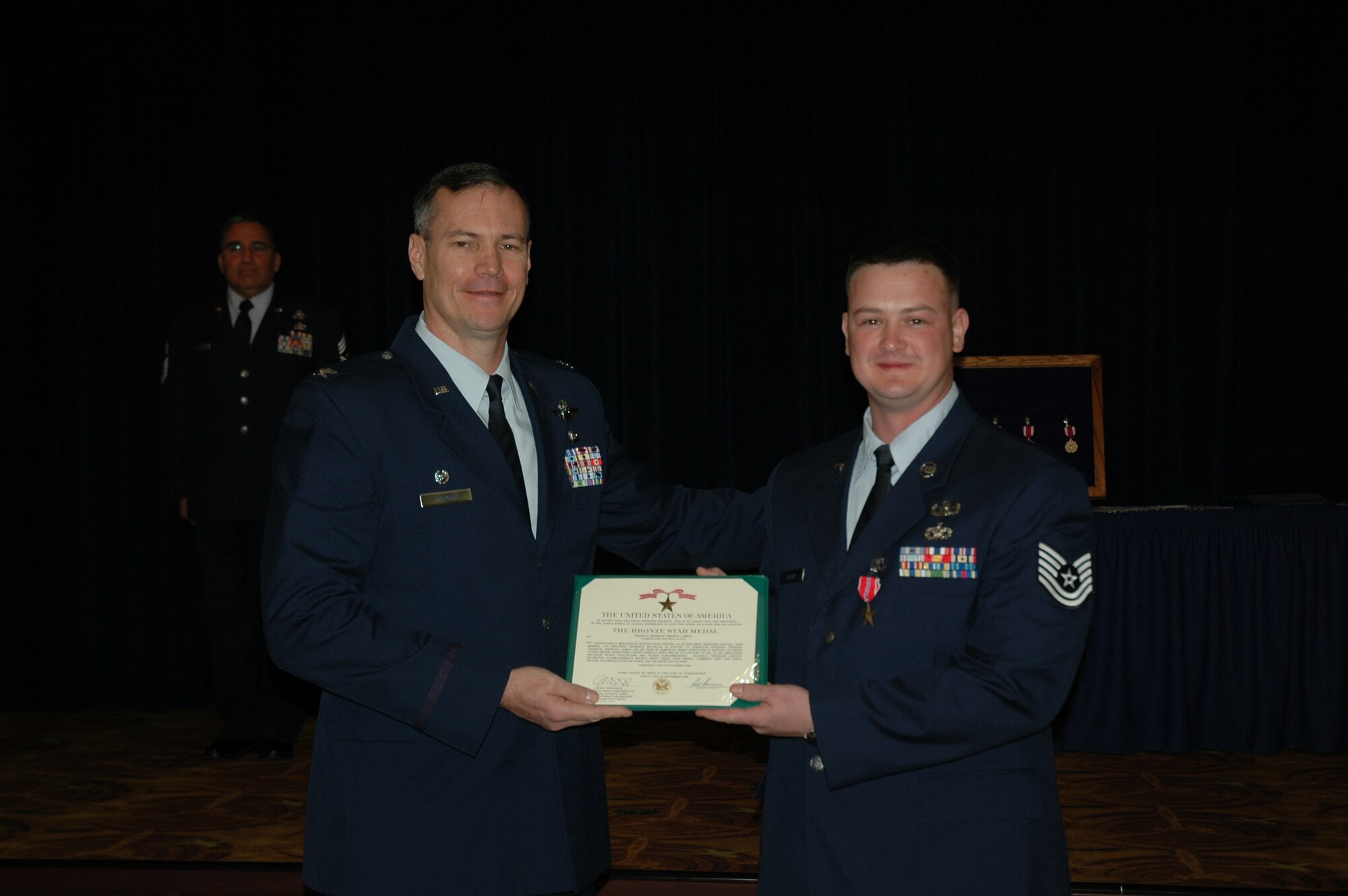 Col. Michael Popovich, 944th Fighter Wing commander, presents Tech. Sgt.
Andrew LeBeau, 944th Civil Engineer Squadron Explosive Ordnance Disposal
technician, the Bronze Star during commander's call March 6. Sergeant LeBeau
received the medal for meritorious service while deployed to Afghanistan
from May to November 2009. (U.S. Air Force photo/Staff Sgt. Denise Willhite)
