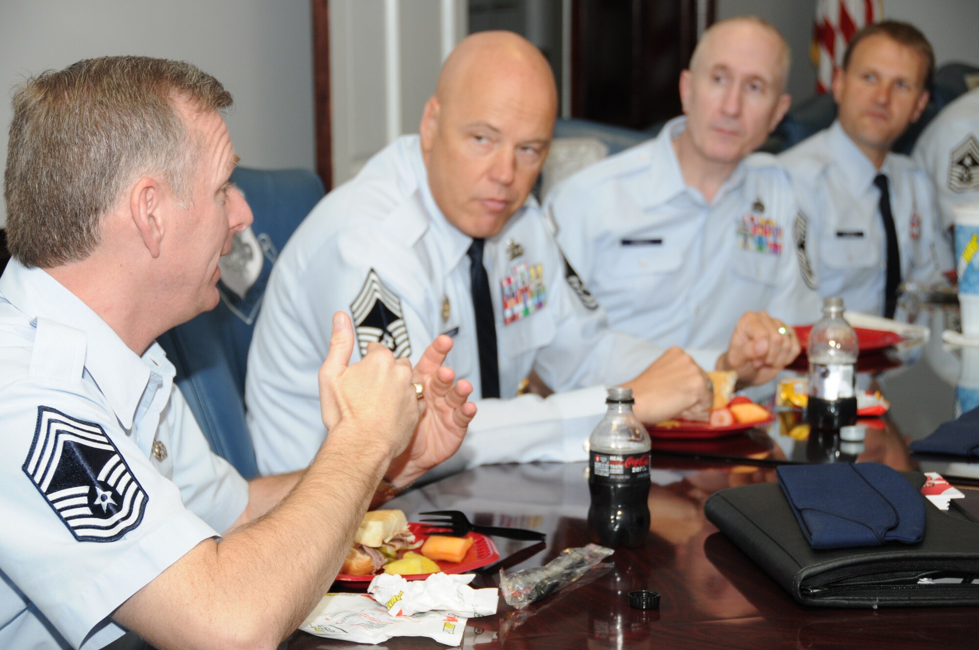 Chief Master Sgt. Jeffry Helm, Army and Air Force Exchange Service senior enlisted adviser, chats with Chief Master Sgts. Billy Abbott, Colin O'Neill and Mike Wood during a luncheon April 5 at 81st Training Wing headquarters.  Chief Helm visited Keesler to participate in the ribbon-cutting of the new base exchange April 6.  Chief Abbott is from the 81st Training Group, Chief O'Neill is with the wing's inspector general's office and Chief Wood is assigned to the 81st Inpatient Operations Squadron.  (U.S. Air Force photo by Kemberly Groue)