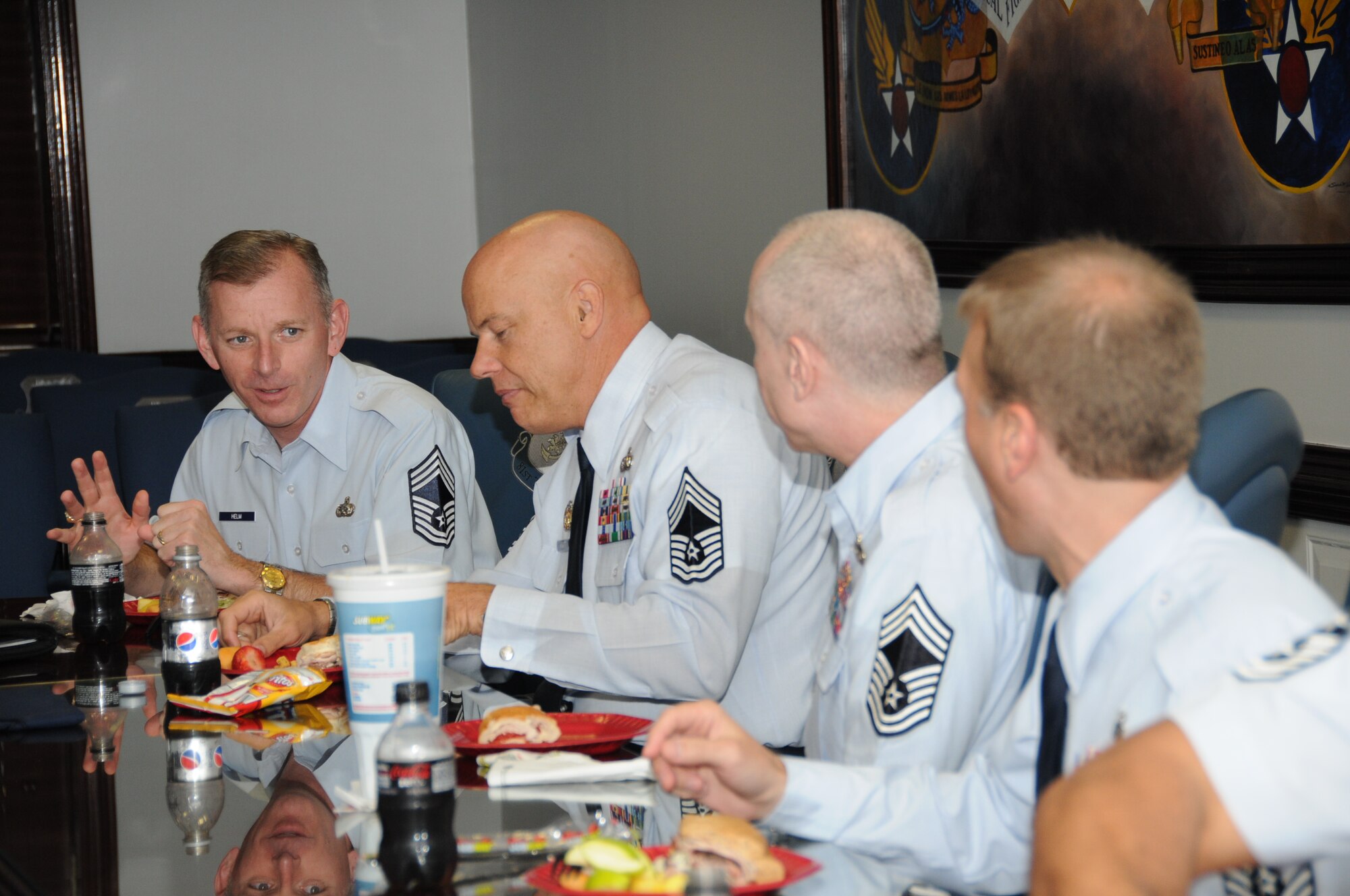 Chief Master Sgt. Jeffry Helm, Army and Air Force Exchange Service senior enlisted adviser, chats with Chief Master Sgts. Billy Abbott, Colin O'Neill and Mike Wood during a luncheon April 5 at 81st Training Wing headquarters.  Chief Helm visited Keesler to participate in the ribbon-cutting of the new base exchange April 6.  Chief Abbott is from the 81st Training Group, Chief O'Neill is with the wing's inspector general's office and Chief Wood is assigned to the 81st Inpatient Operations Squadron.  (U.S. Air Force photo by Kemberly Groue)